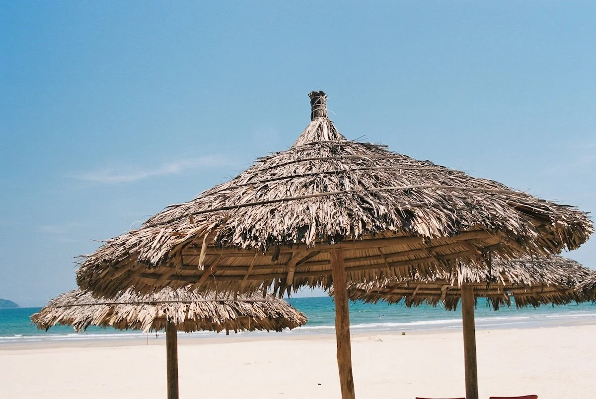 Da Nang Vietnam proposal photographer – tropical beach hut on My Khe Beach, perfect for romantic engagement moments