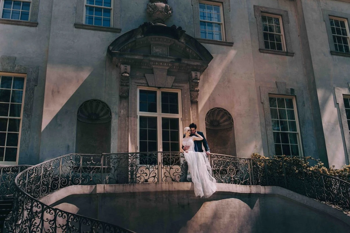 Editorial inspired wedding portrait — bride standing with elegance on the grand stone steps.