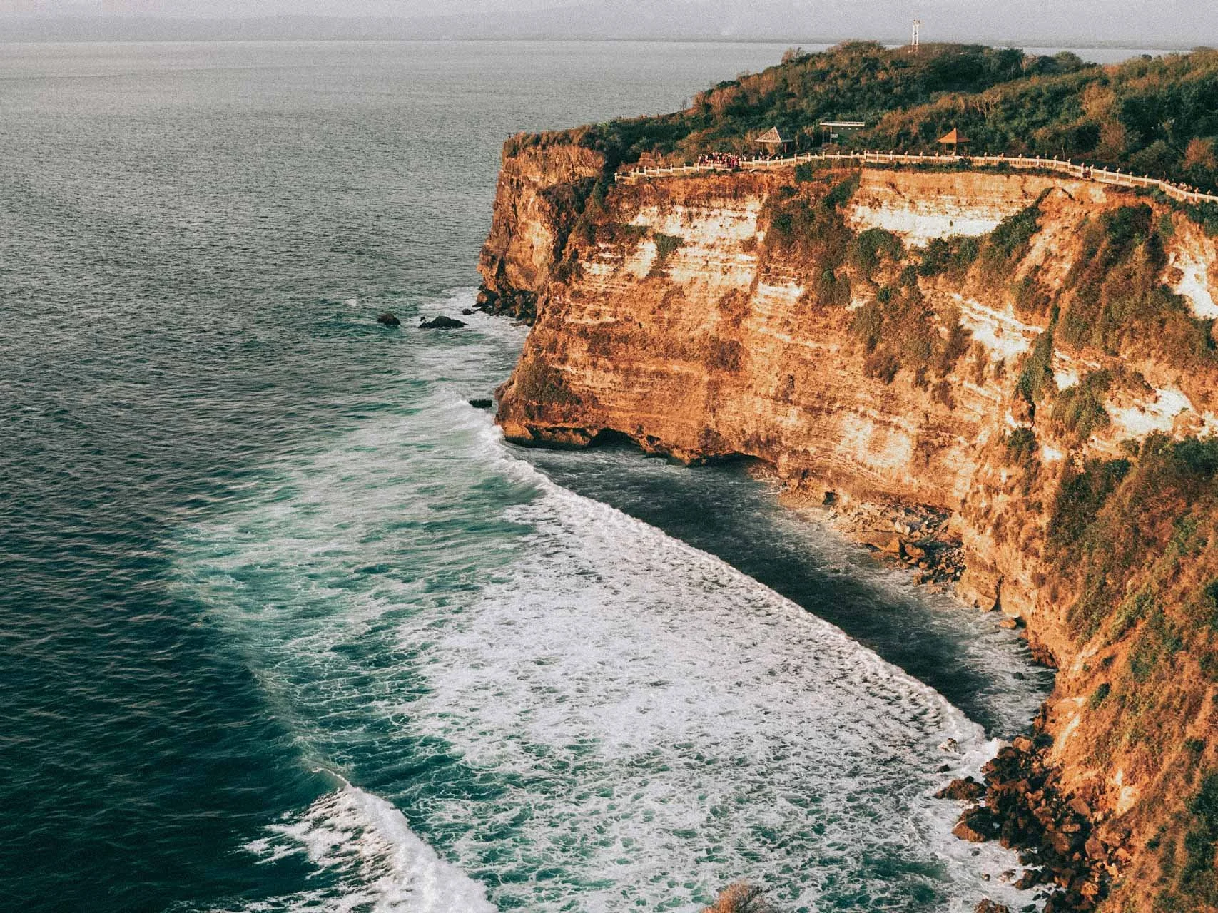 Clifftop in Uluwatu on the Bali coast framed in aerial view, imagery aligned with Bali wedding photographer style