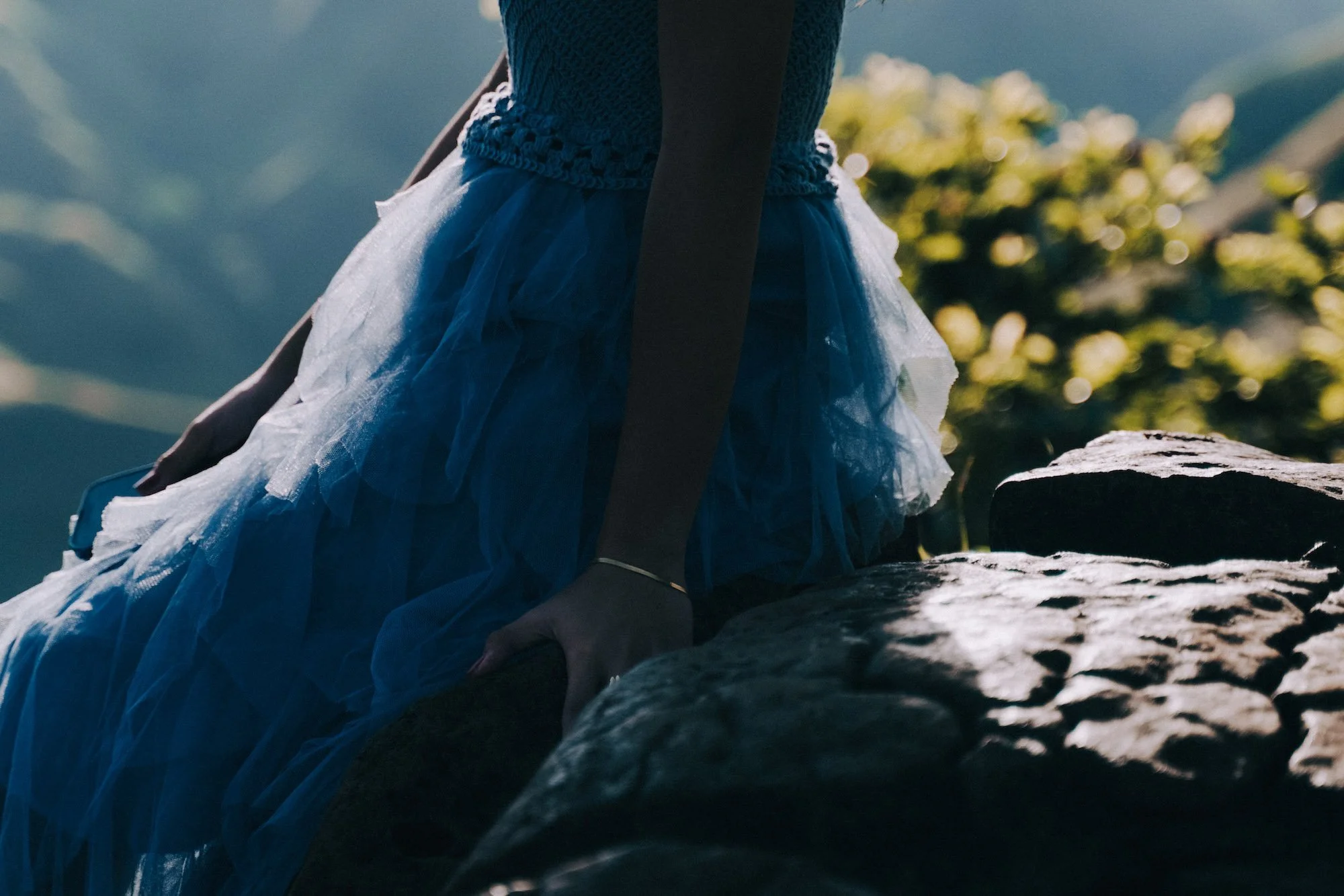 Detail of a flowing dress caught in motion, fabric glowing under soft light, cinematic and intimate