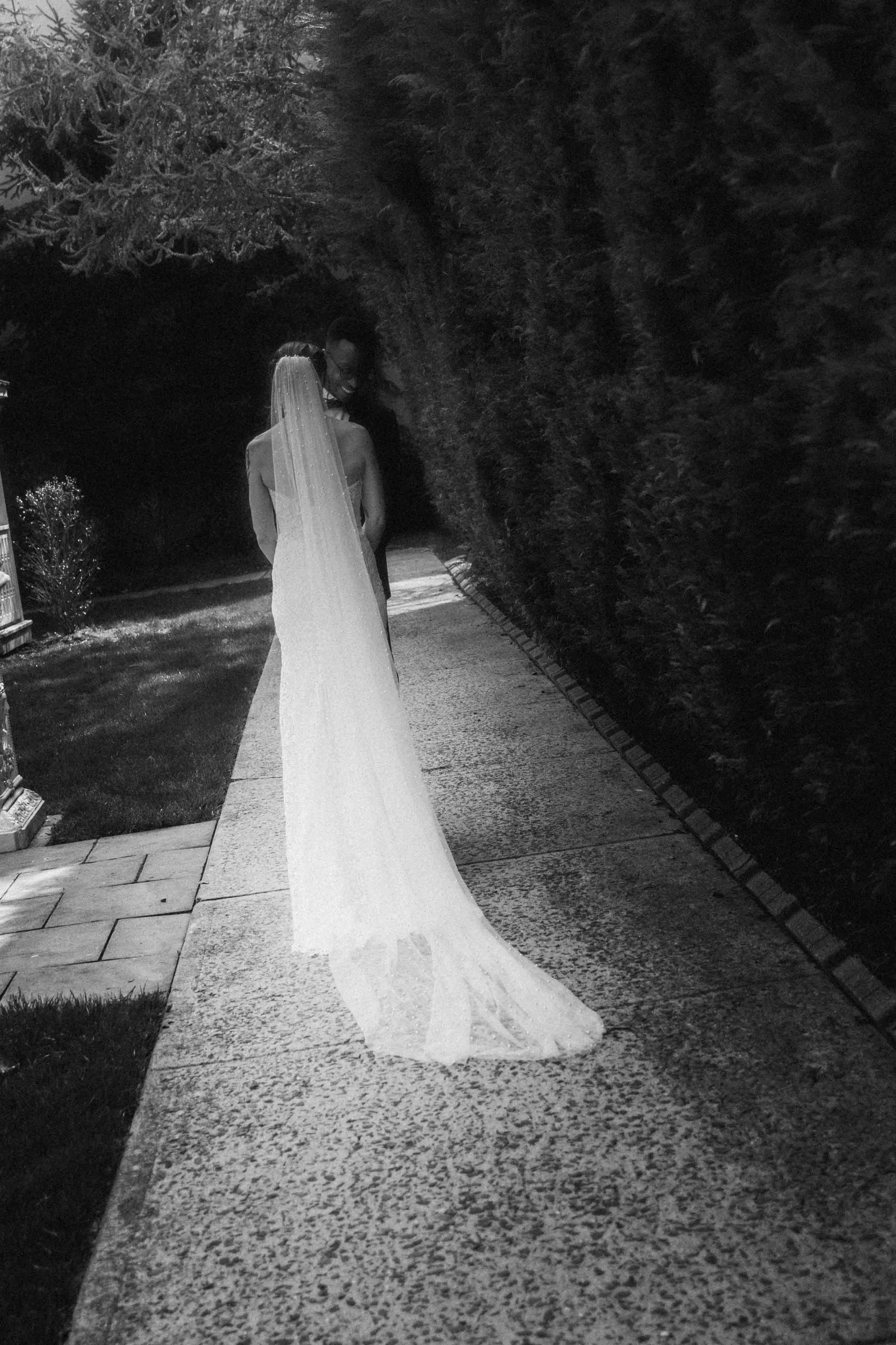 Bride walks along a stone path, veil trailing in soft light — an elegant moment inspired by Awasi Patagonia’s serene isolation.