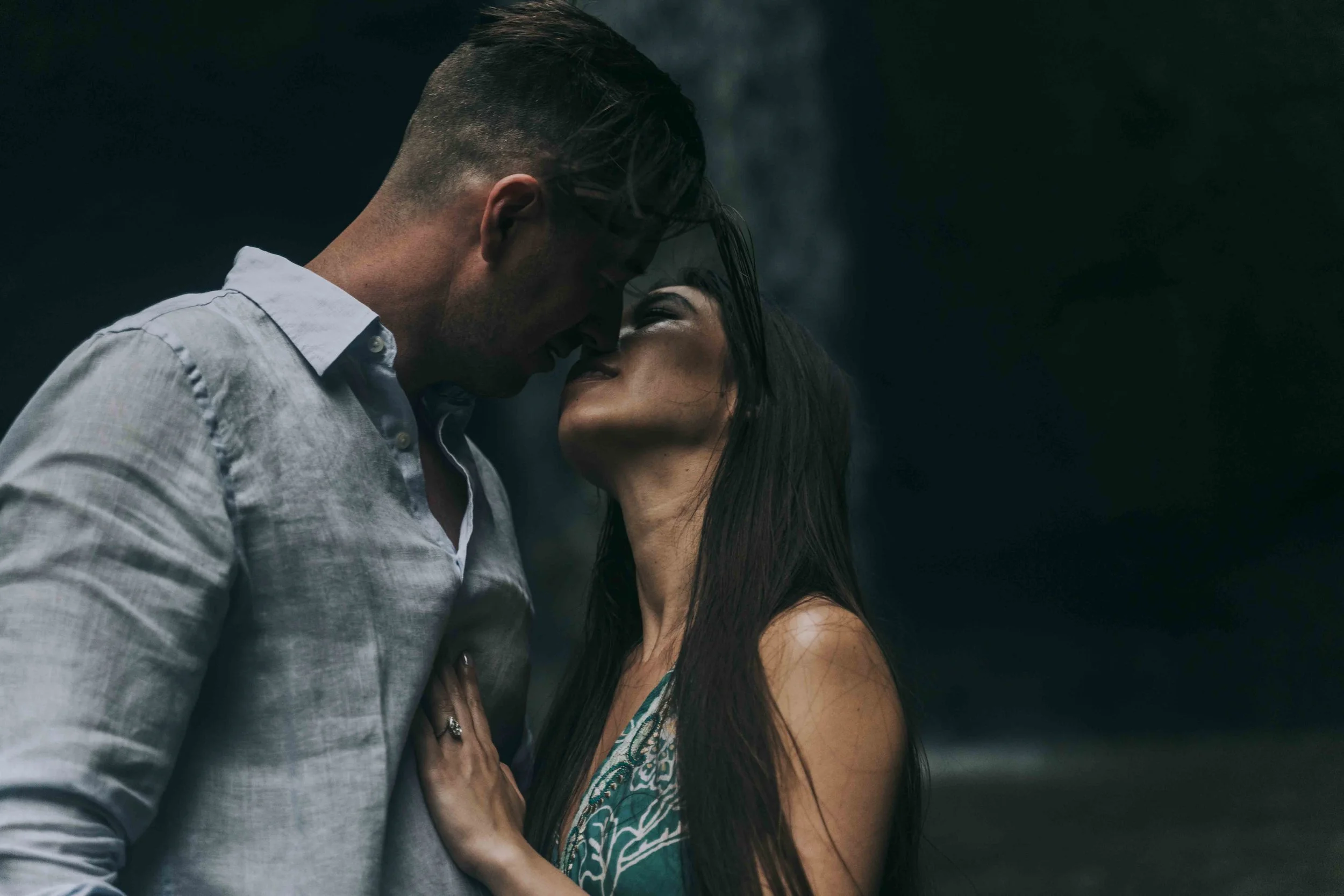 A couple stands close with foreheads touching beside falling water, photographed by Fragmented Memories prenup photographer in a steady, unposed moment.