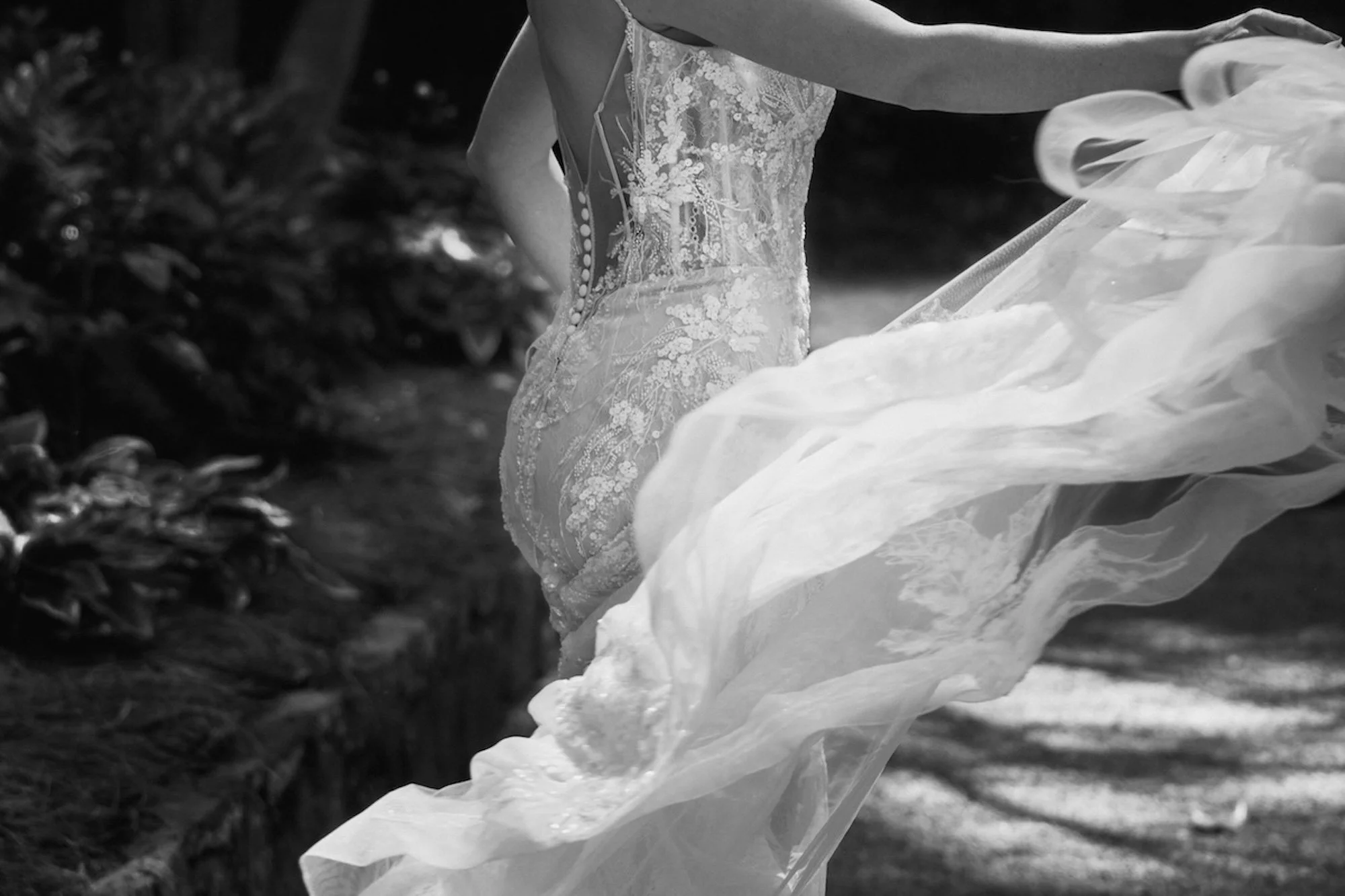 The movement of a gown caught mid-sway, fabric flowing with elegance, a moment shaped into art.