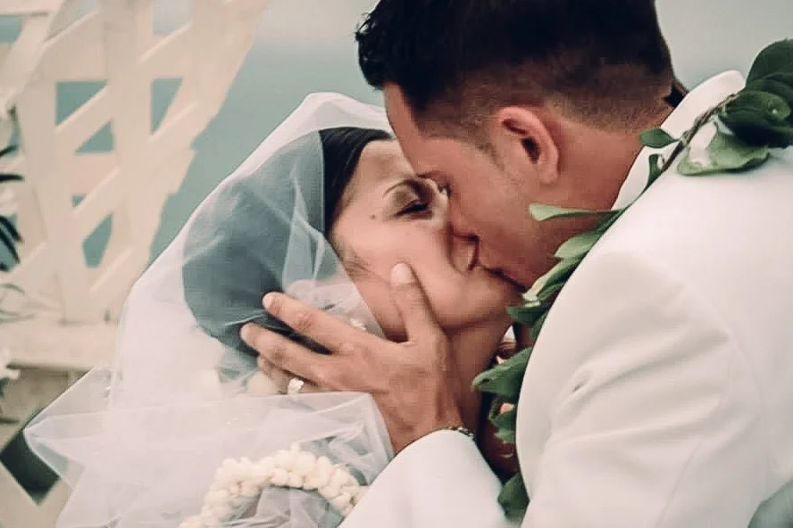 couples first kiss on a beach wedding