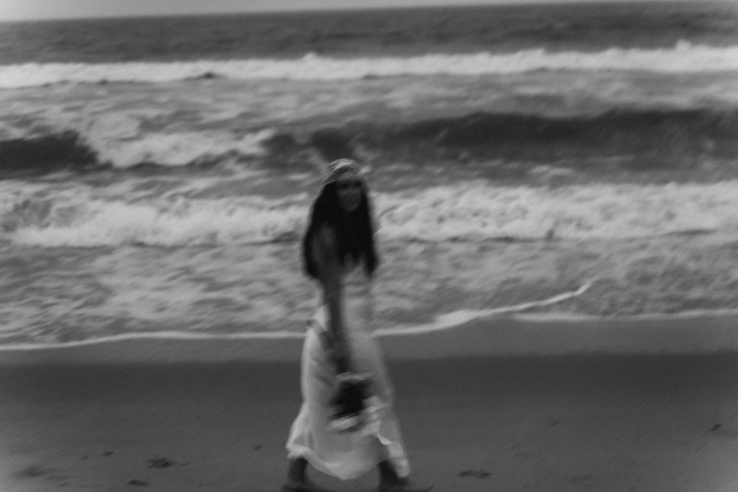 A couple leans toward each other inside a vehicle, their faces partially obscured by reflections, captured by a Fragmented Memories prenup photographer.