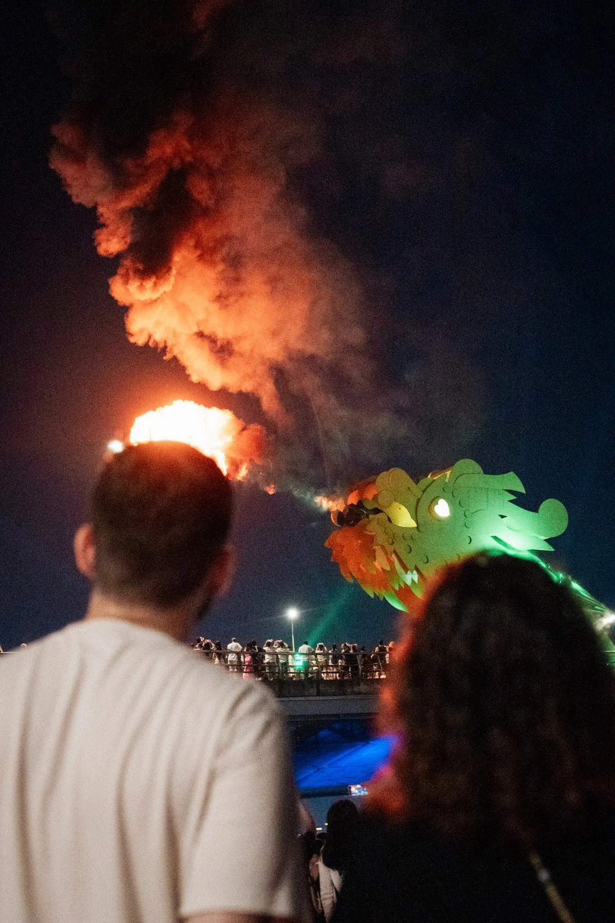 Da Nang proposal photographer — Dragon Bridge fire show at night, cinematic skyline backdrop in Vietnam.