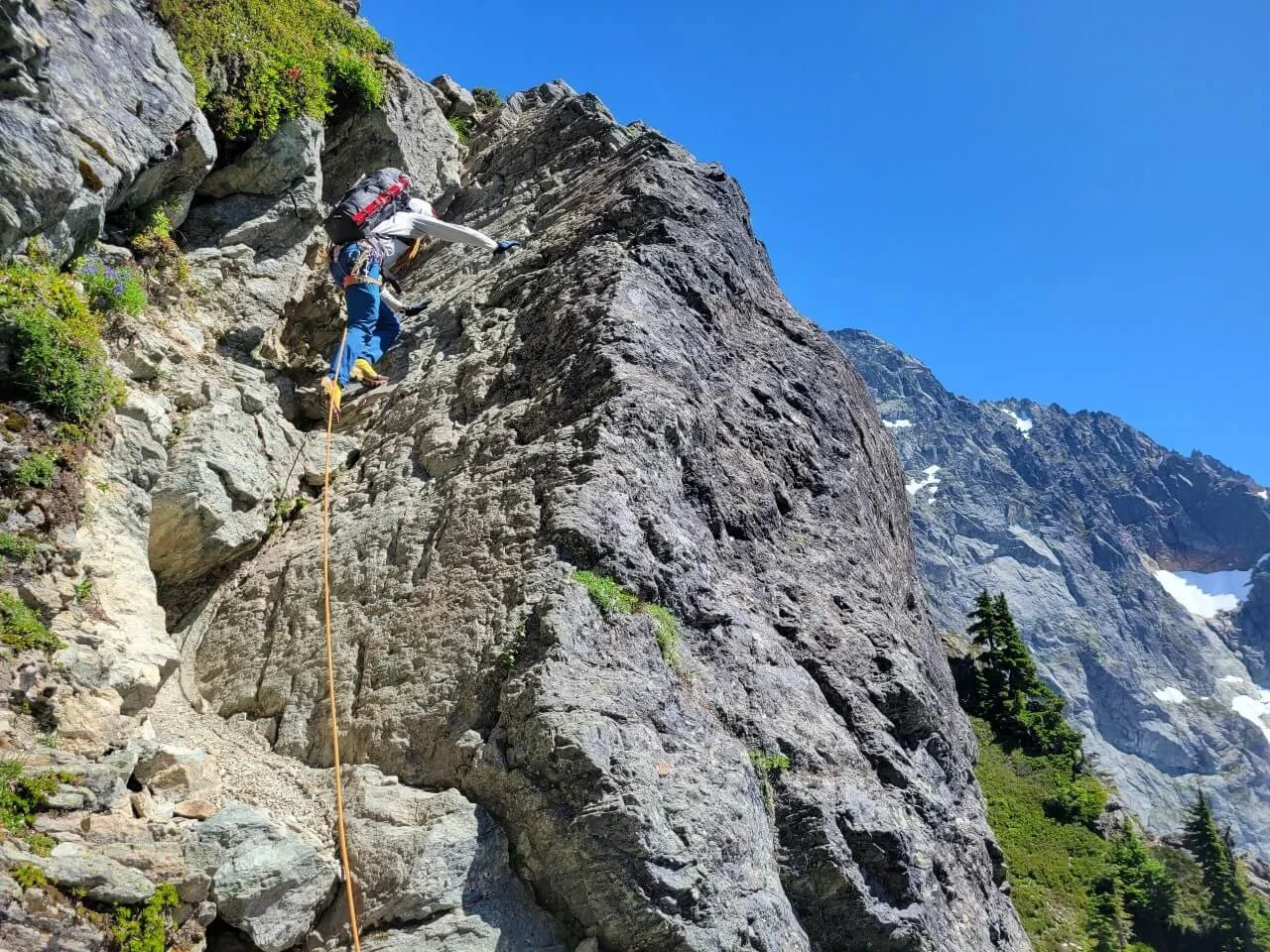 Climbing a rock step in the Fisher Chimneys on Mount Shuksan.