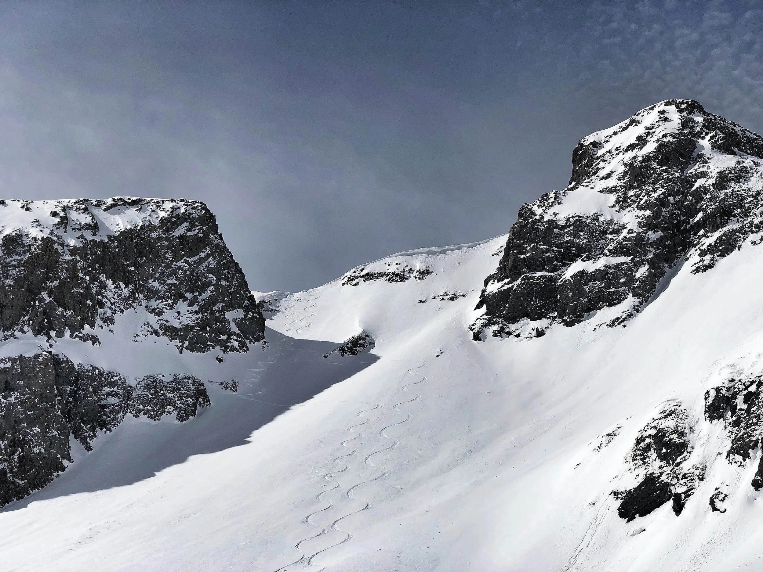 Ski tracks down a steep snow face on Red Mountain Pass.