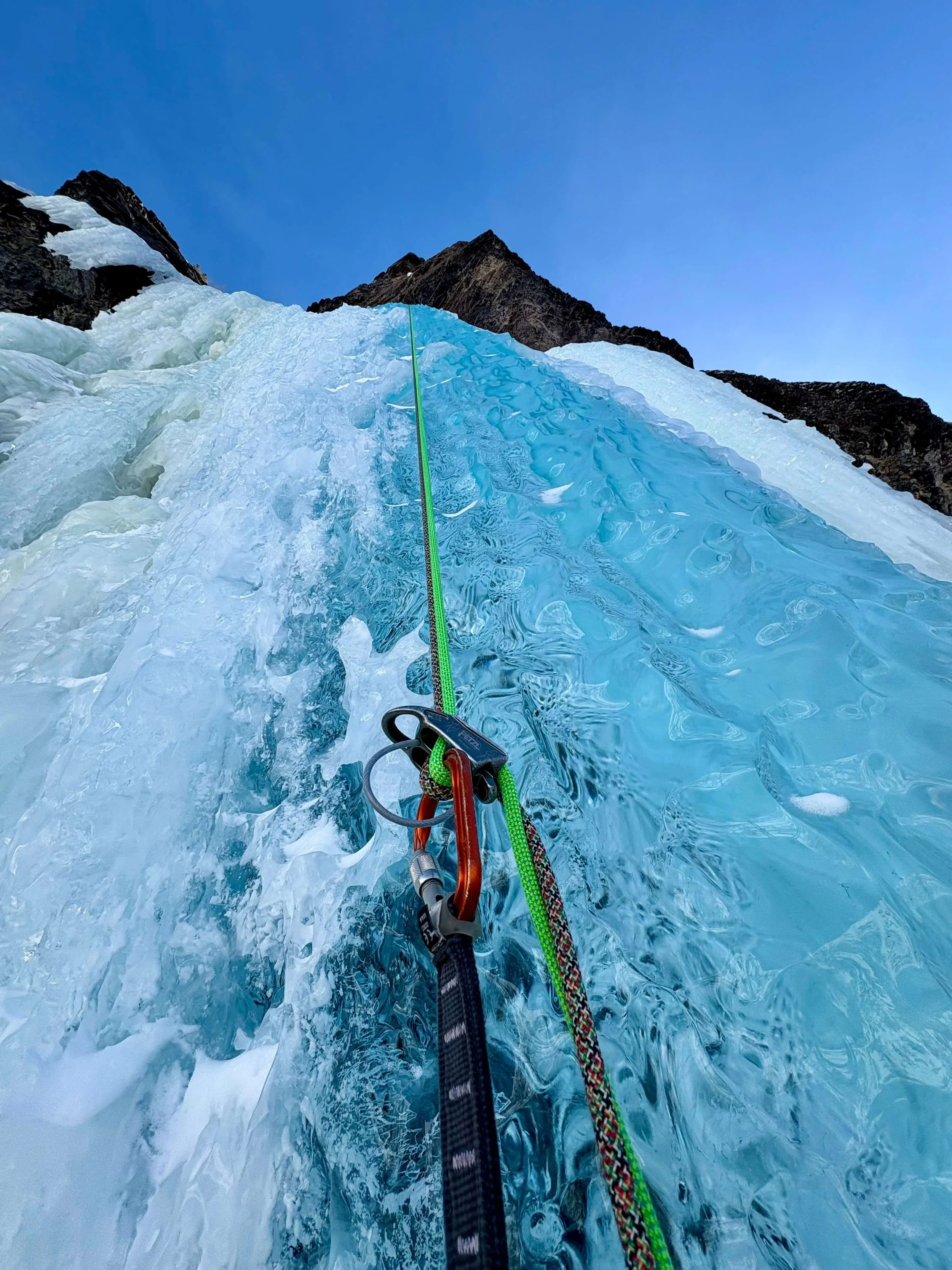 Rappelling a blue pillar of ice on Bridal Veil Falls in Telluride, Colorado.