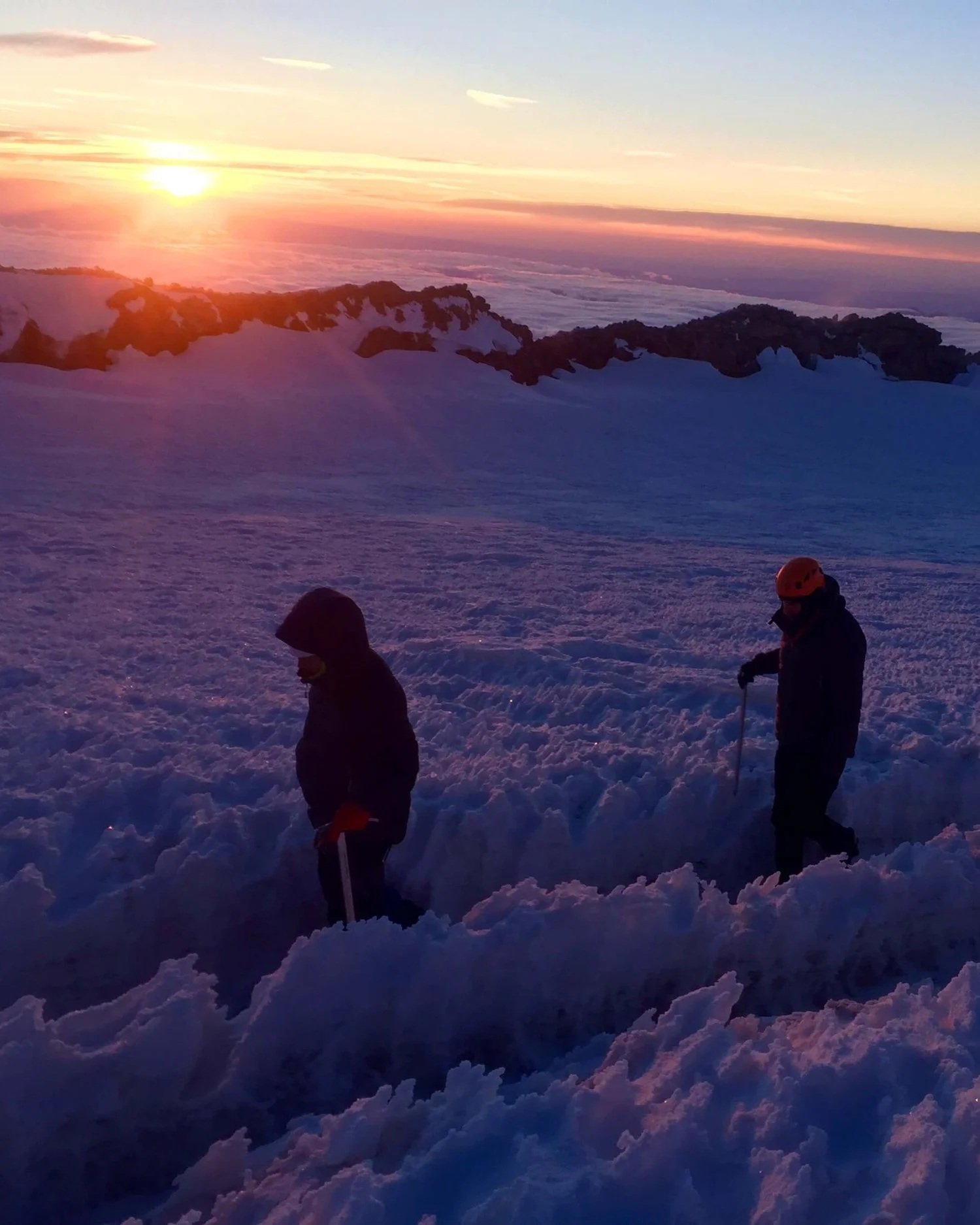 Traversing the summit crater of Mount Rainier after a successful guided climb.