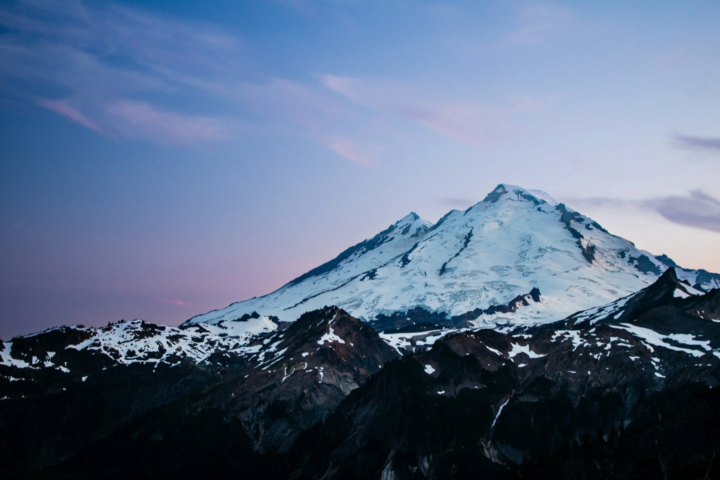 Purple alpenglow lights up the Coleman Glacier on Mount Baker.