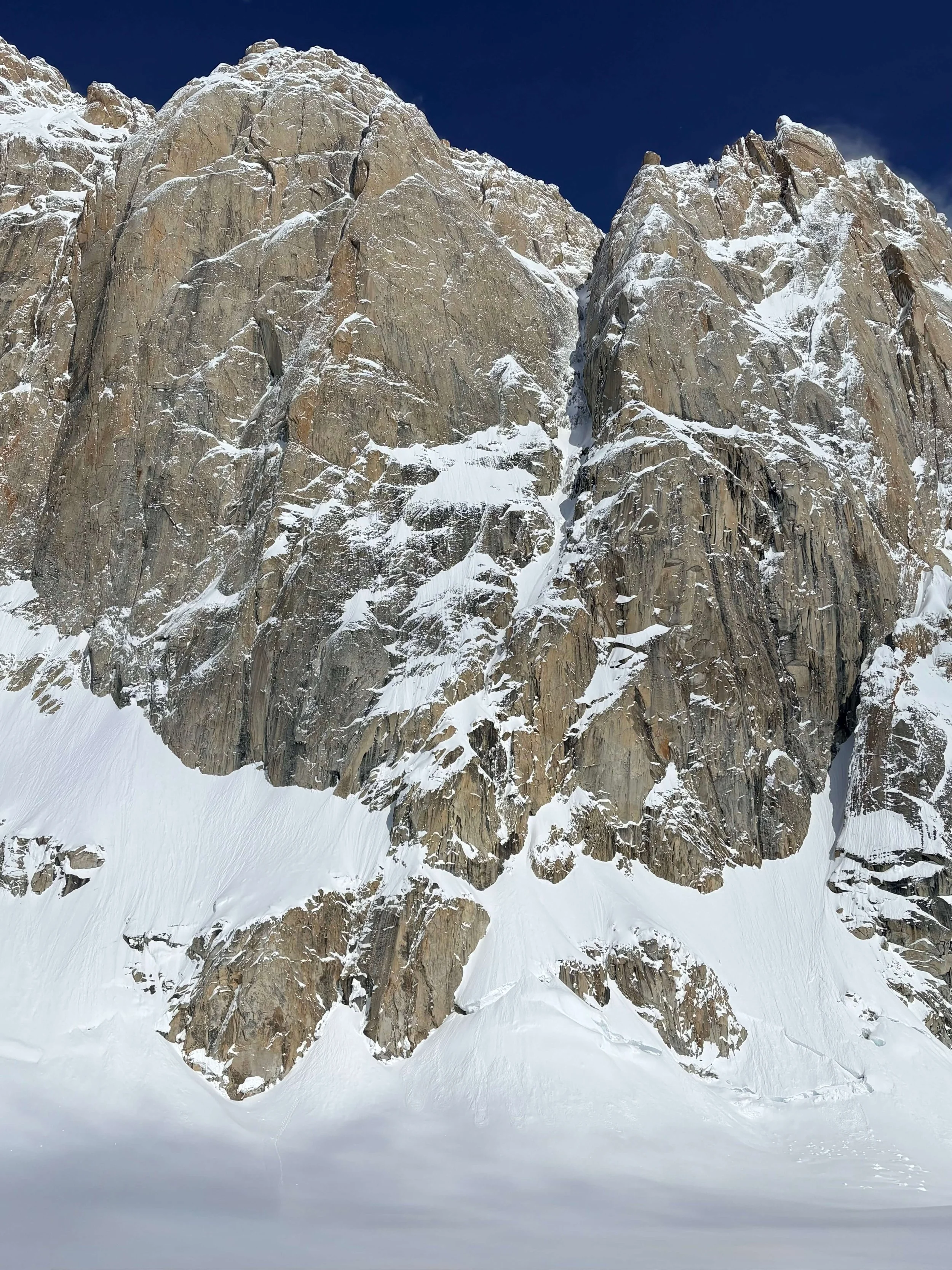An overview of the Ham and Eggs route, it follows the snowy line cutting through the central buttress of granite.