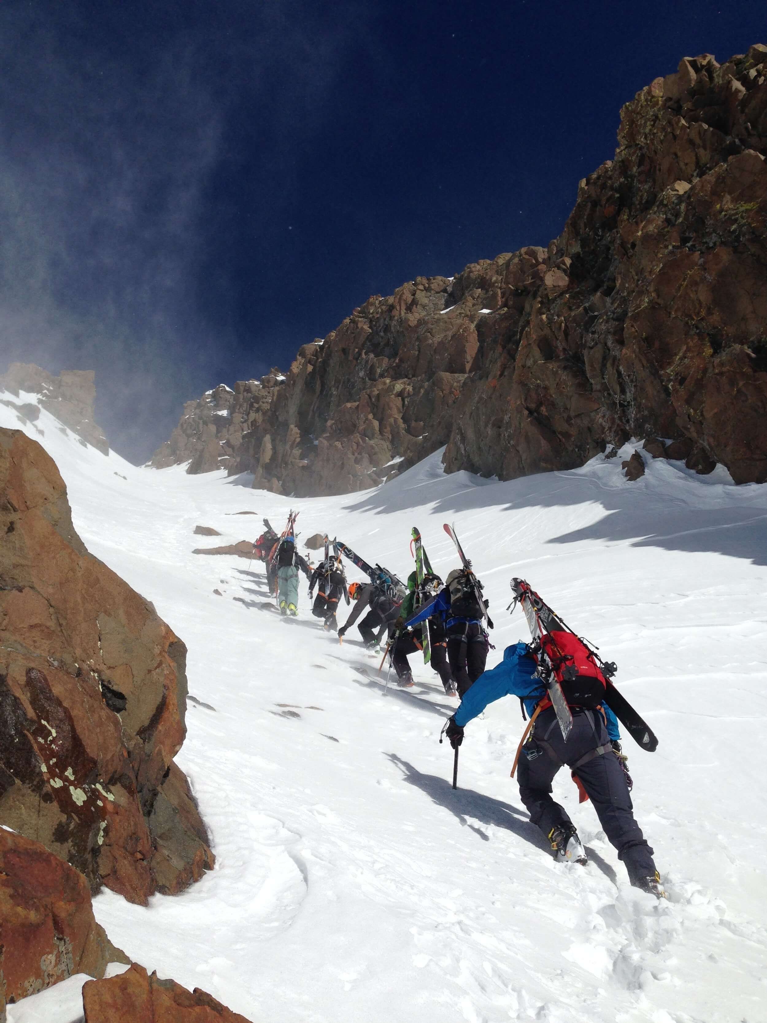 Climbing up a steep snow couloir.