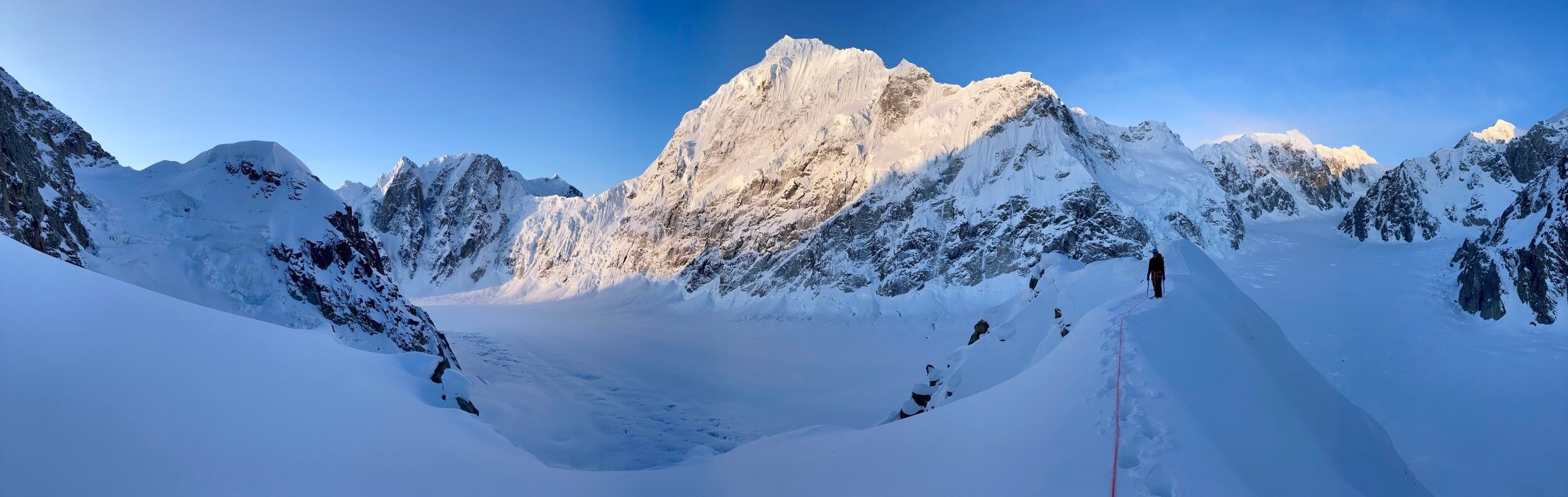 Alpenglow on Mt. Huntington while starting up the Southwest Ridge of Peak 11,300.