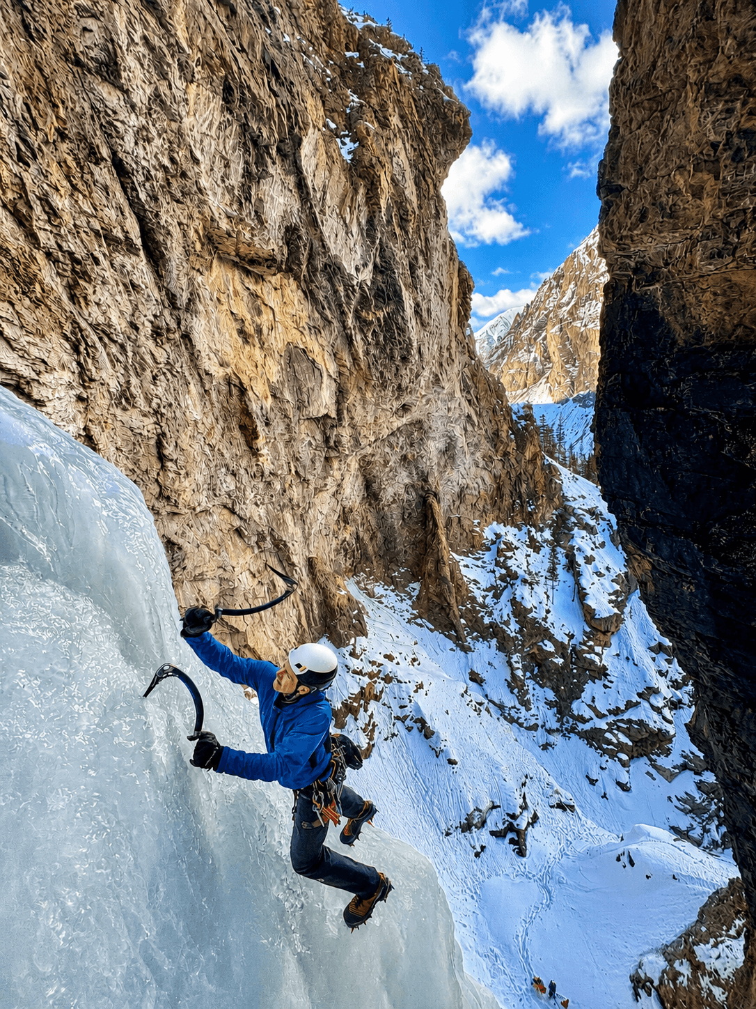 A guide is leading the dramatic first pitch of Captain Roos in Eureka, Colorado.