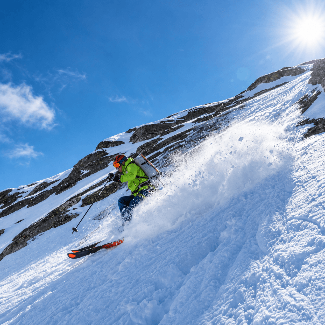 A skier in a green jacket turns in powder during a ski mountaineering course.
