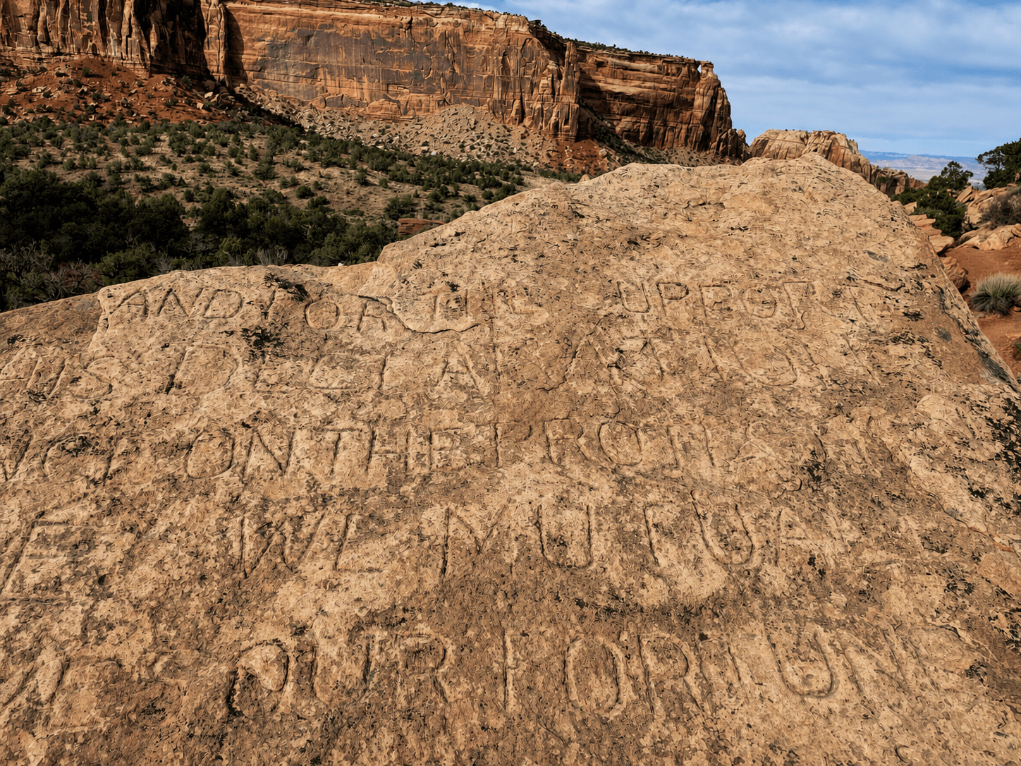 Carved text from the Declaration of Independence at the base of the Independence Monument in Colorado National Monument was from the first ascent.