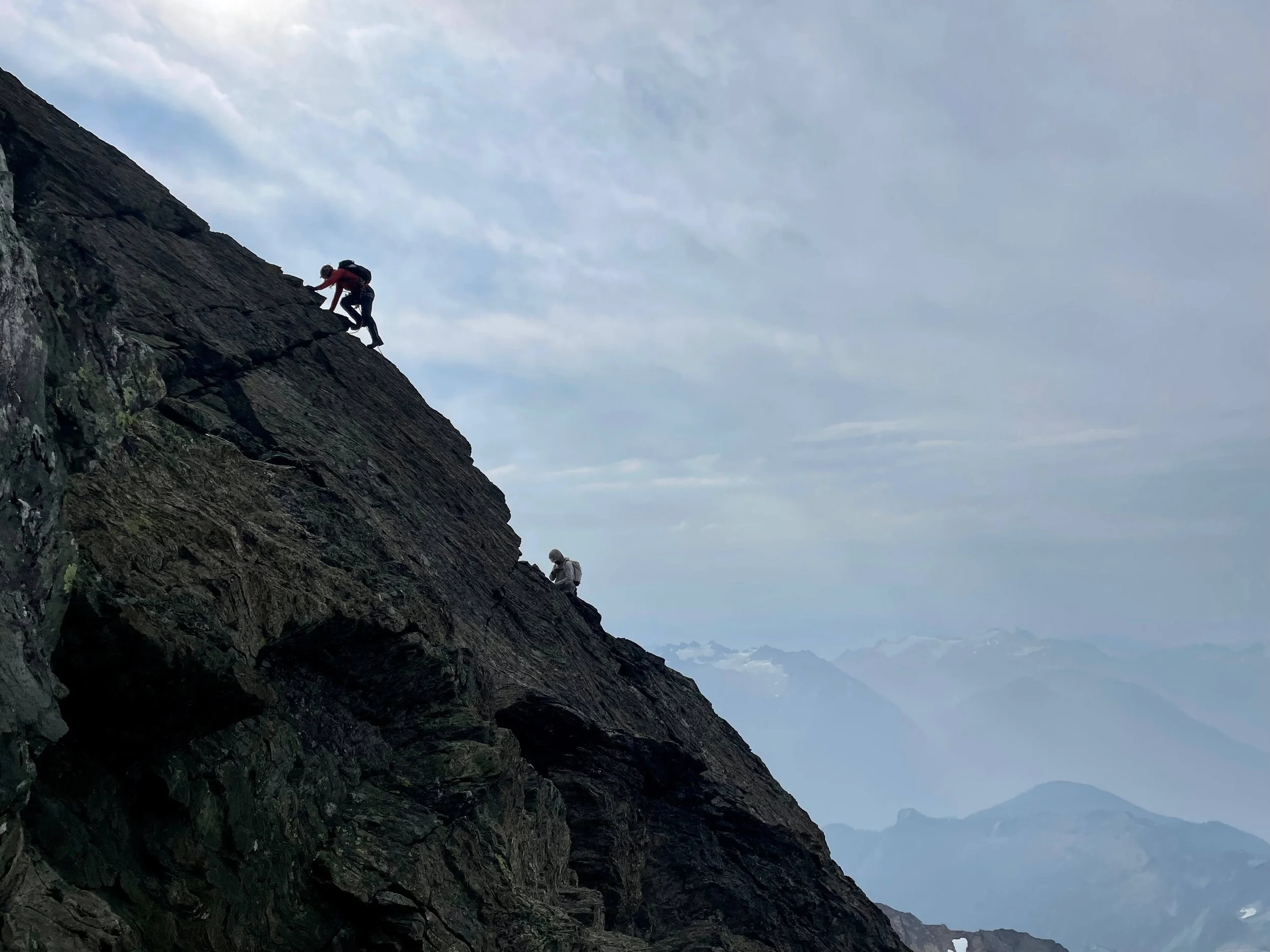 A silhouette of climbers on the summit pyramid of Mt. Shuksan.
