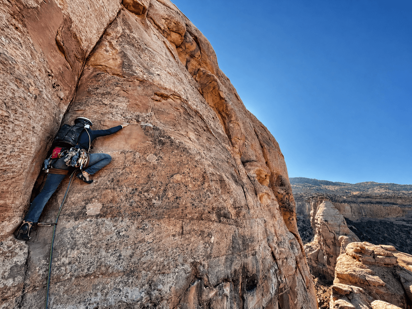 A guide leads a crack pitch on Independence Monument.