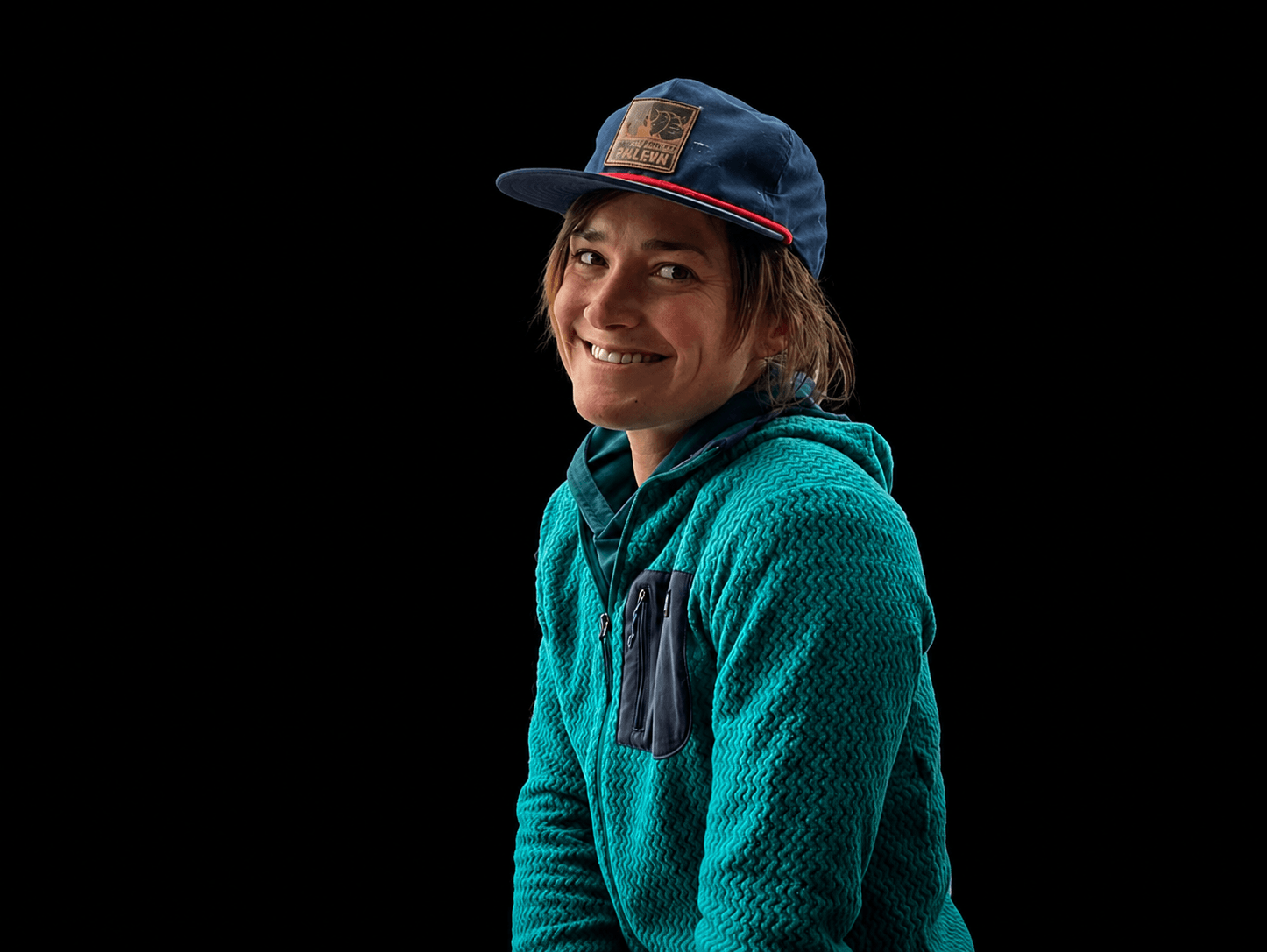 Skyward Mountaineering guide, Suzanna Lourie. She is wearing a blue fleece jacket and a blue baseball hat.