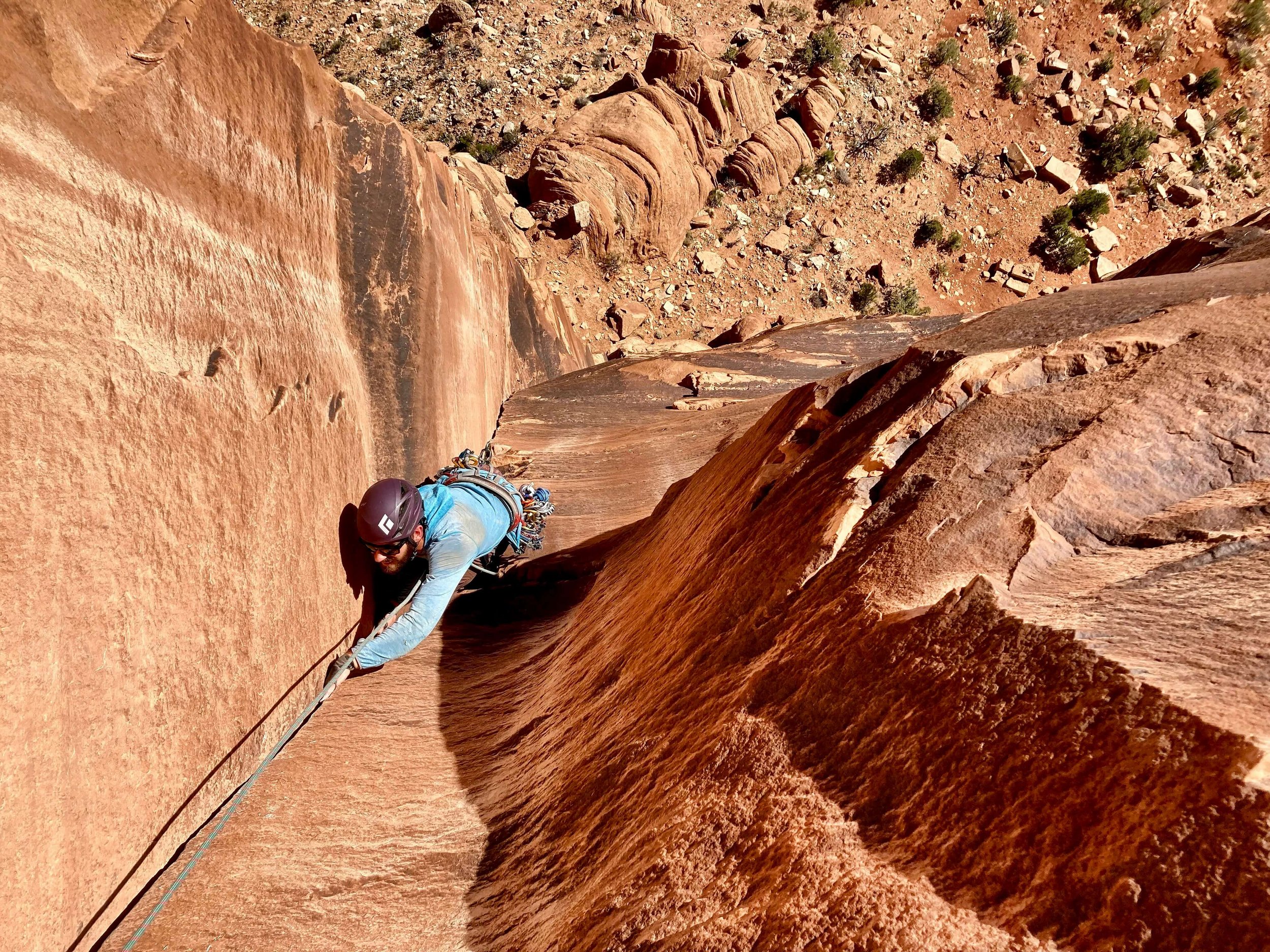 A rock climber hand jams on a desert tower in Colorado National Monument.