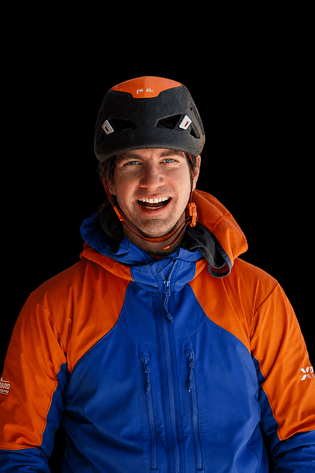 Skyward Mountaineering guide, Bobby Cosker, is wearing a blue and orange jacket with a black helmet during a day of guiding in the Ouray Ice Park.