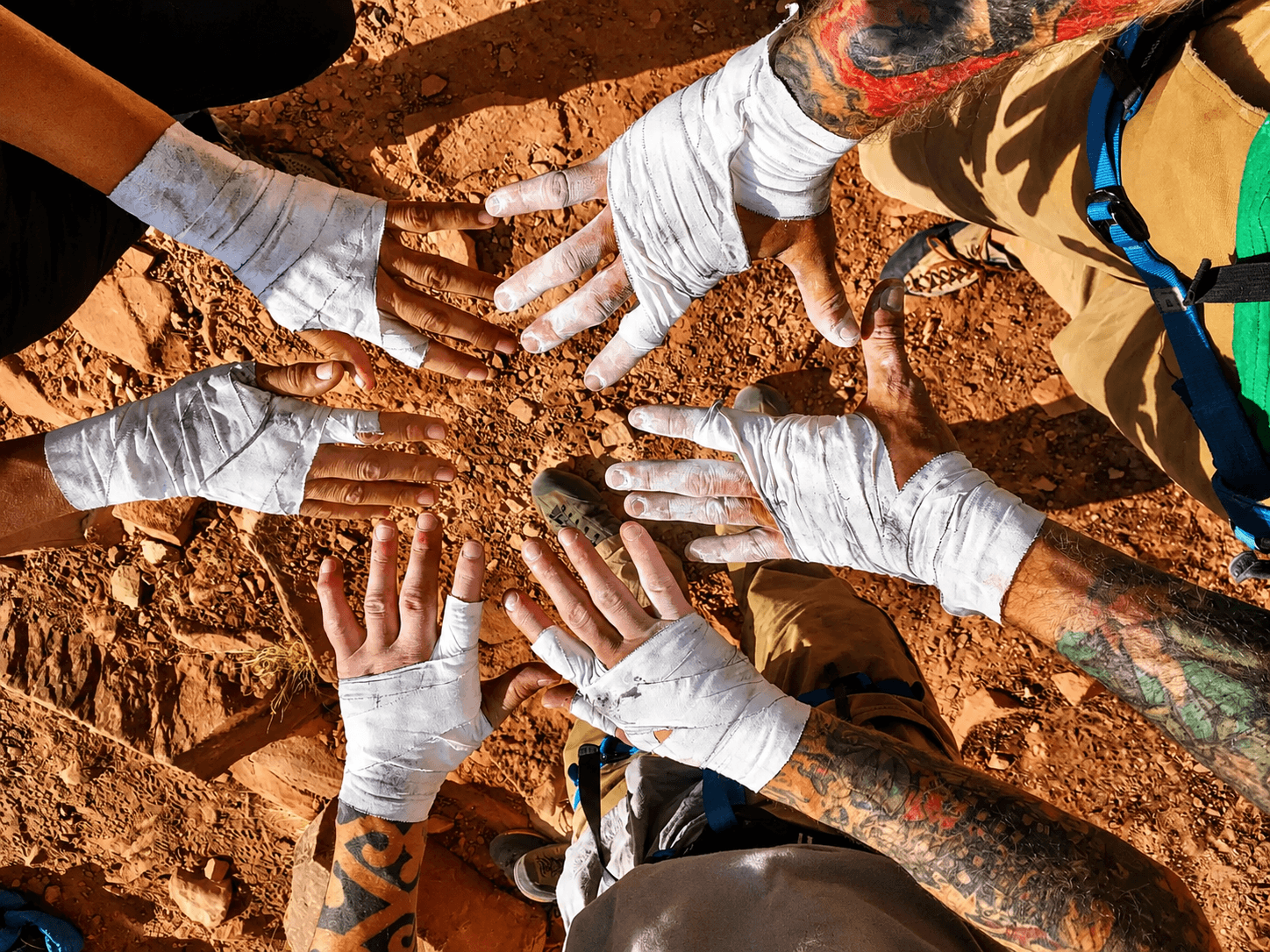 A group of climbers shows off their tape gloves during a crack climbing course in Colorado.