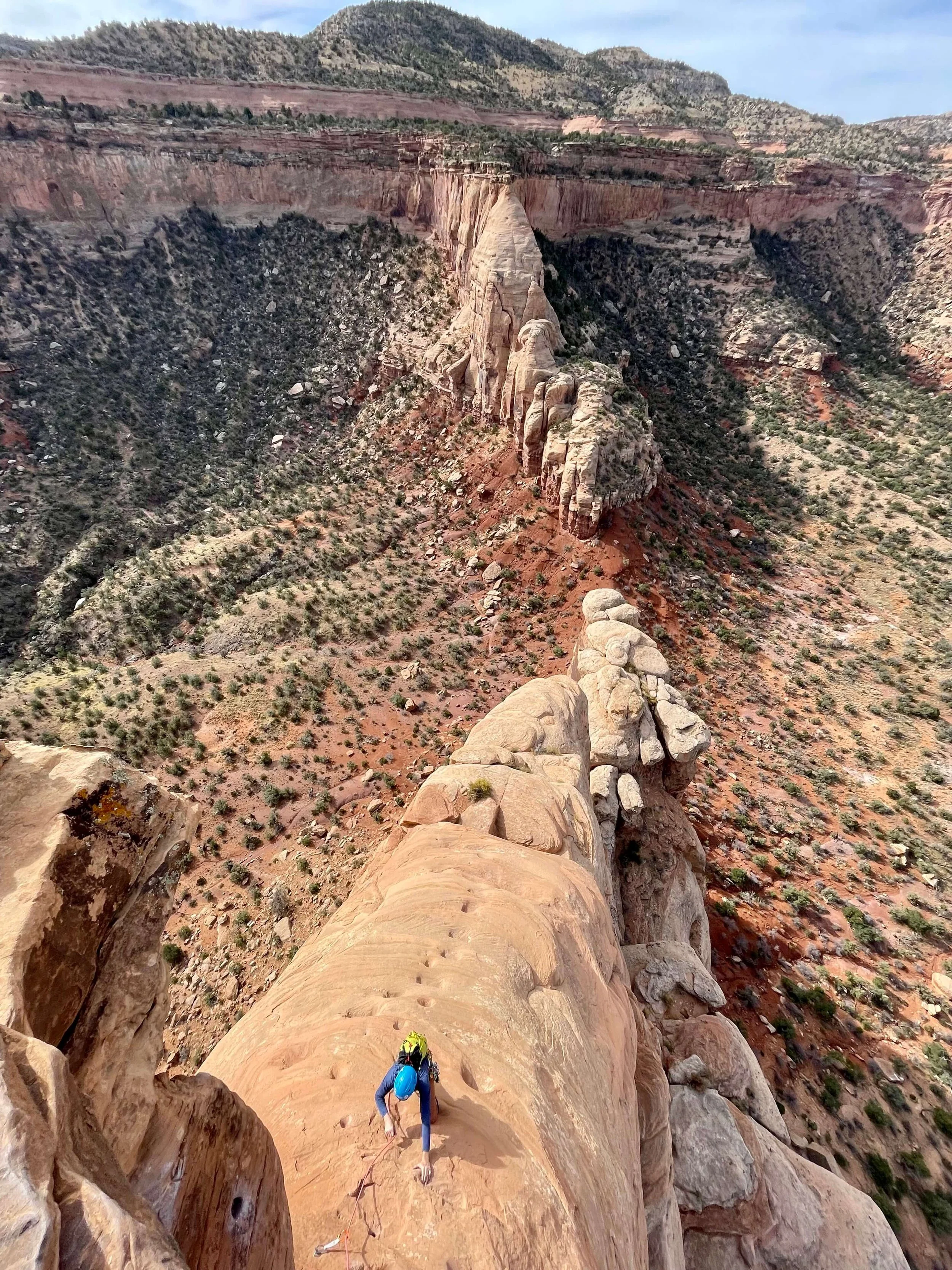 A climber ascends the slabby ramp towards the headwall on Otto's Route in Colorado National Monument.