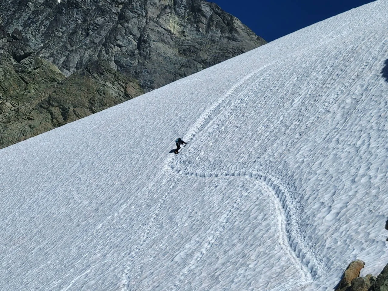 Climbing the steep snow on Winnie's Slide above the Fisher Chimneys on Mount Shuksan.
