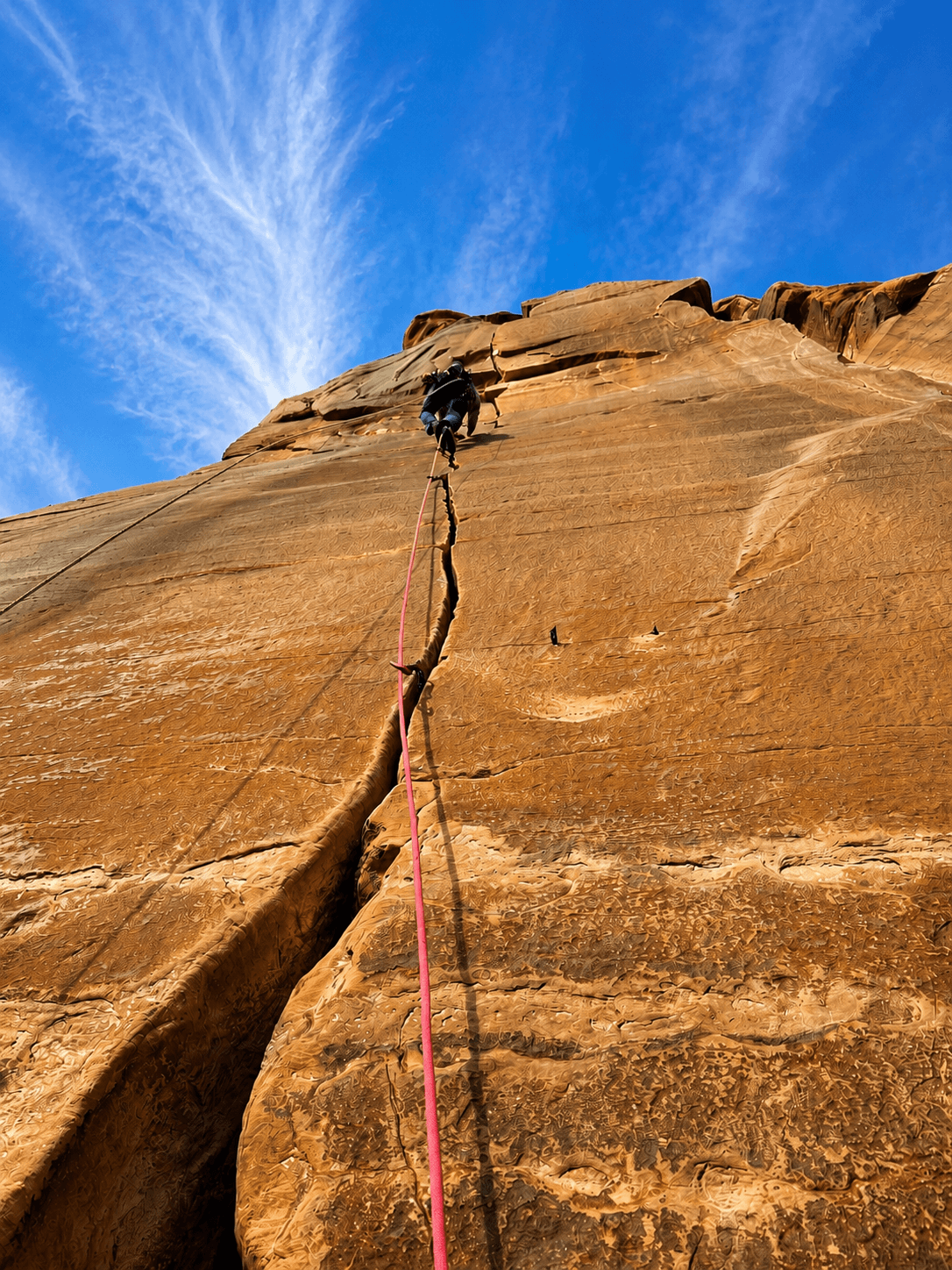 A guide leads a steep crack climbing route during a rock climbing course in Grand Junction.