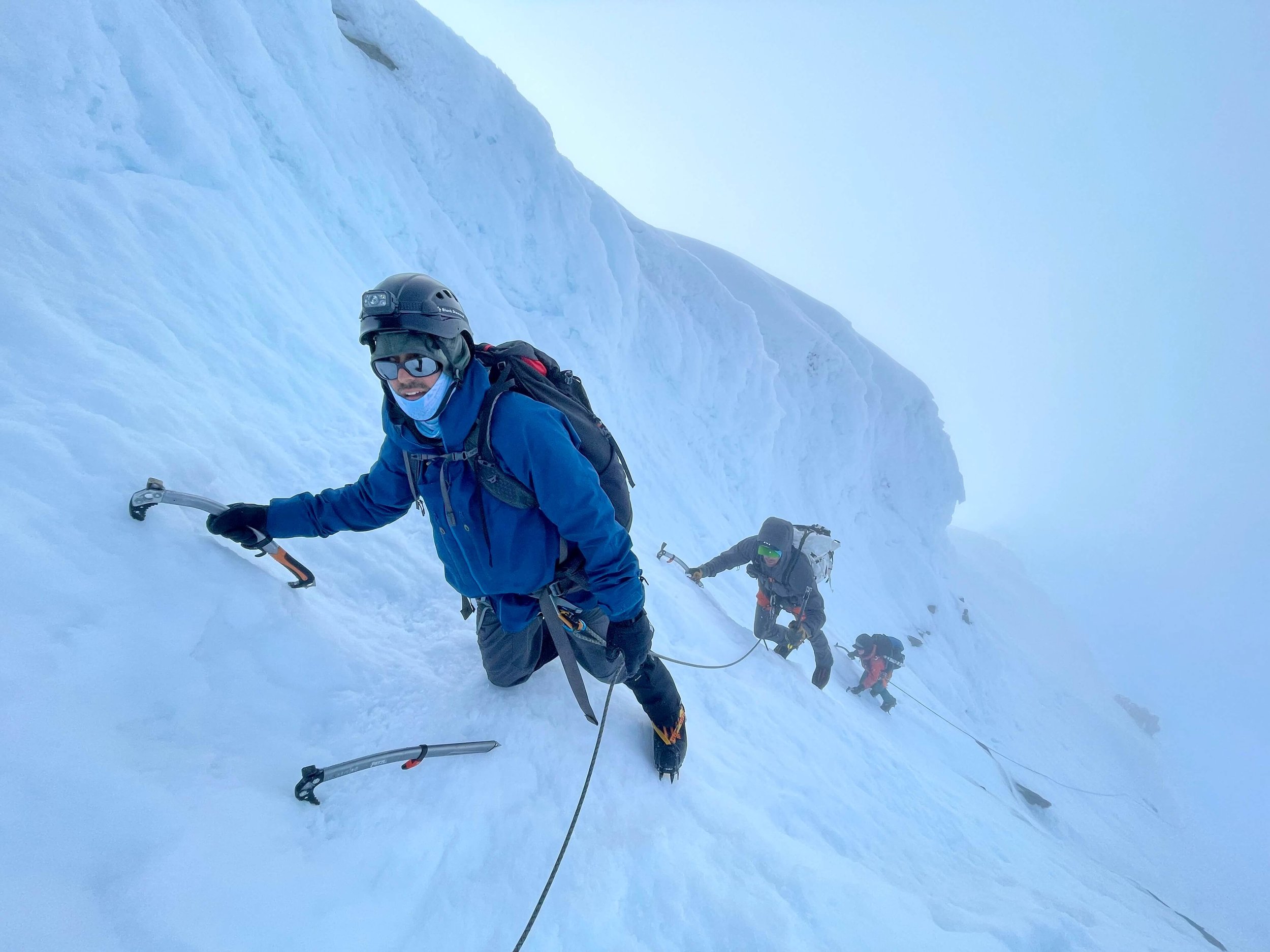 Climbing a snowy summit pyramid on Mt. Shuksan.