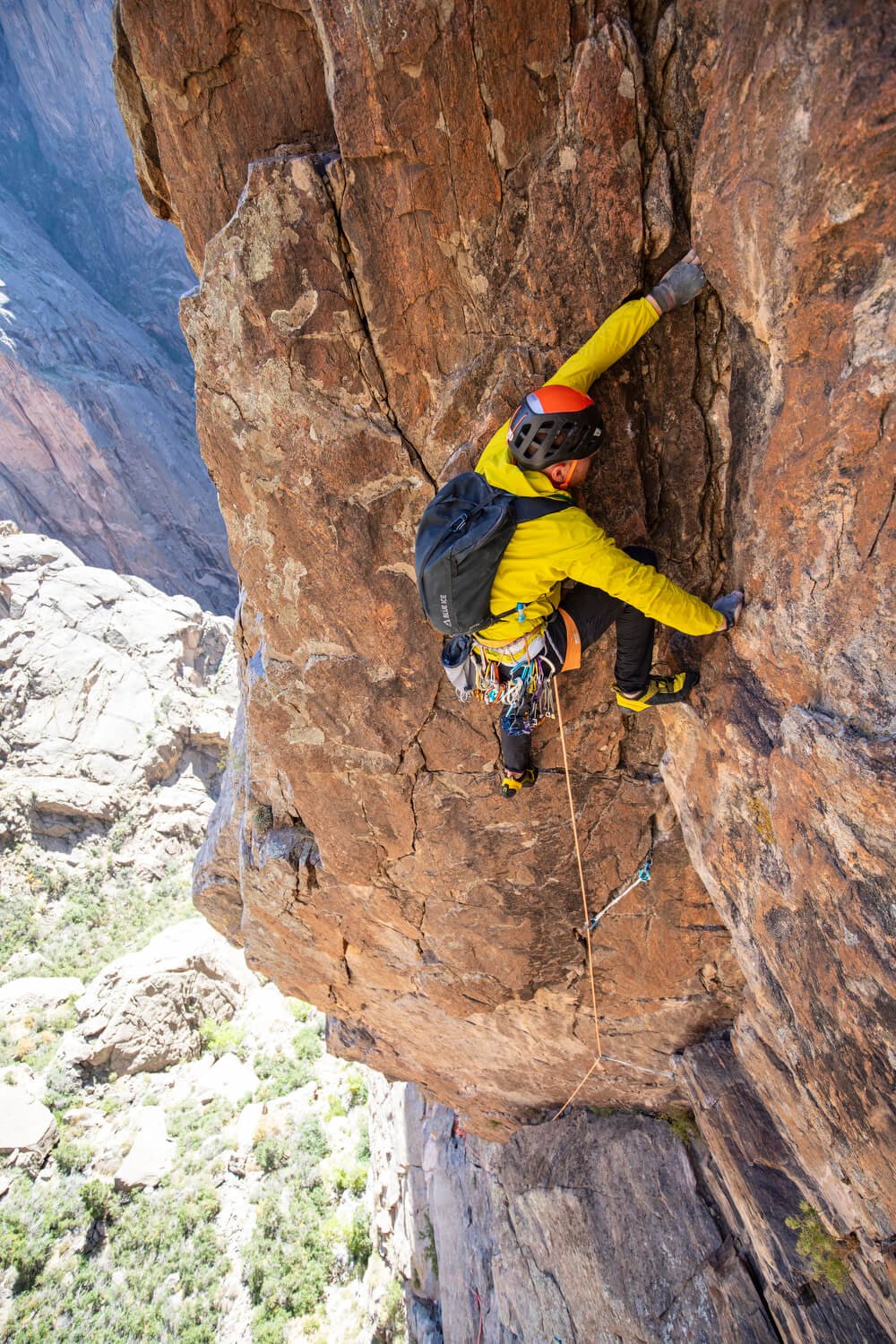 A climber in a yellow jacket is leading the third pitch on the Midsummer Nights Dream in the Black Canyon.