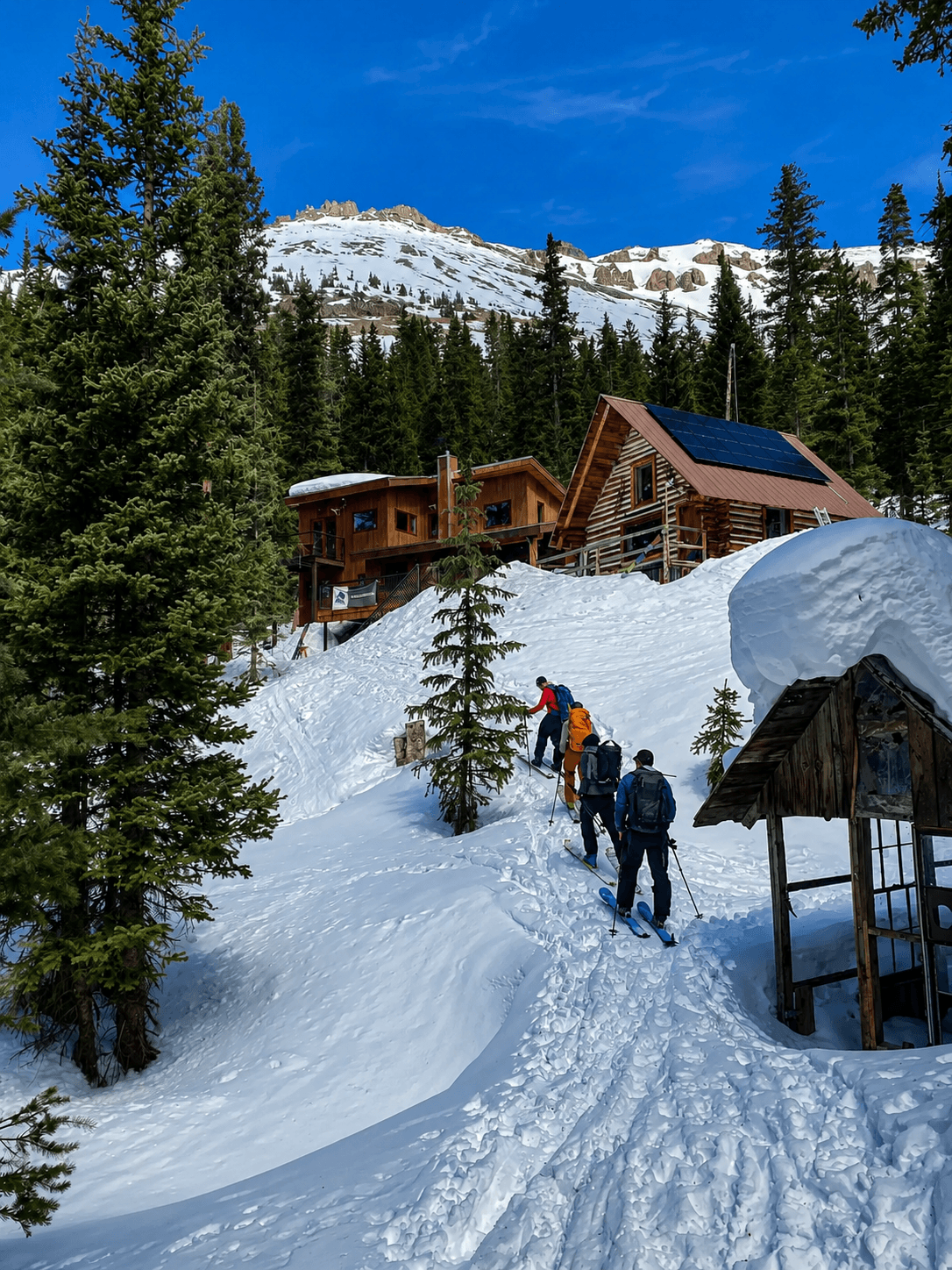 A group of skiers tour up to the Mount Hayden Backcountry Lodge in the San Juan mountains.