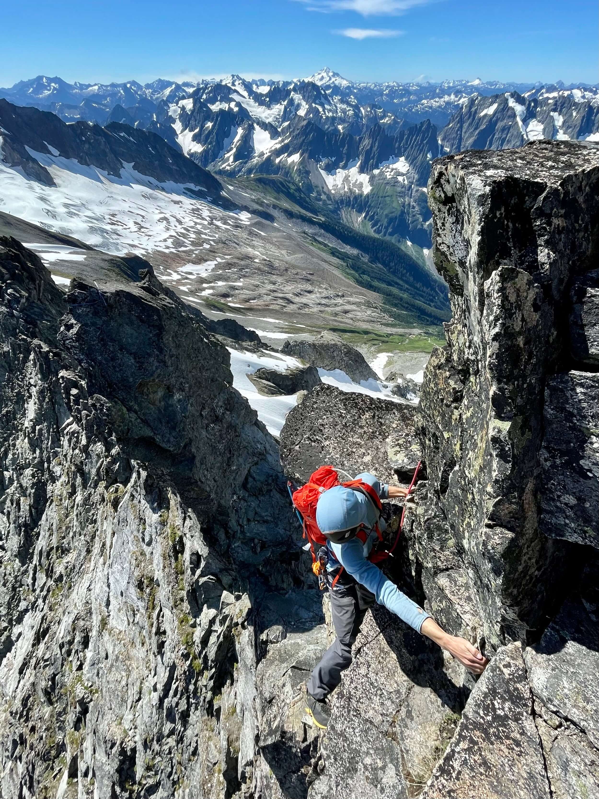 Climbing the crux gendarme on the East Ridge of Forbidden Peak.