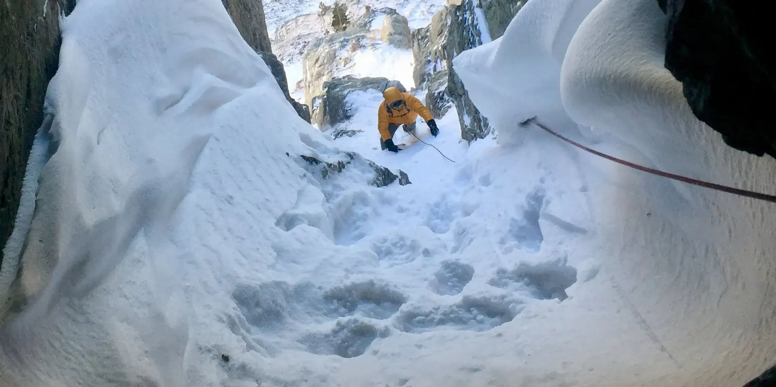 Climbing steep snow at the entrance of a winter ascent on Hallett Chimney.