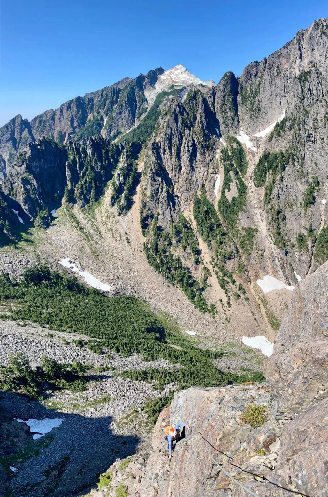 Rock climbing on Vega North Tower with Headlee Pass and Vesper Peak in the background.