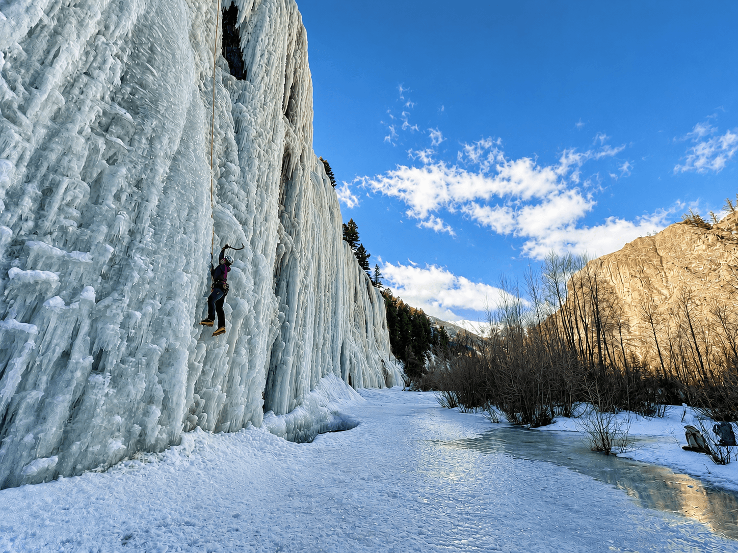 A climber topropes a route in the Lake City Ice Park. A steep wall of ice without any other climbers around.