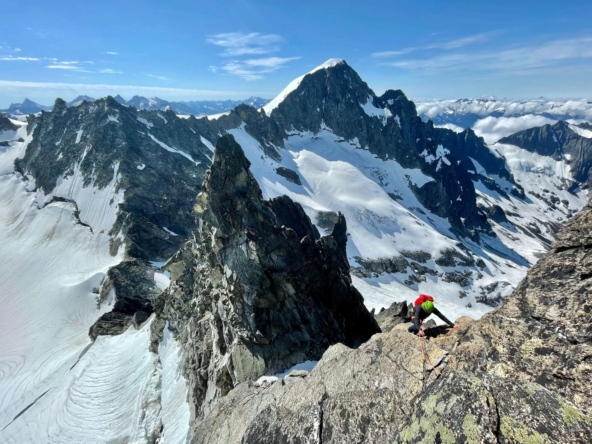 Climbing up the SE Ridge of Dorado Needle with Eldorado Peak in the background.