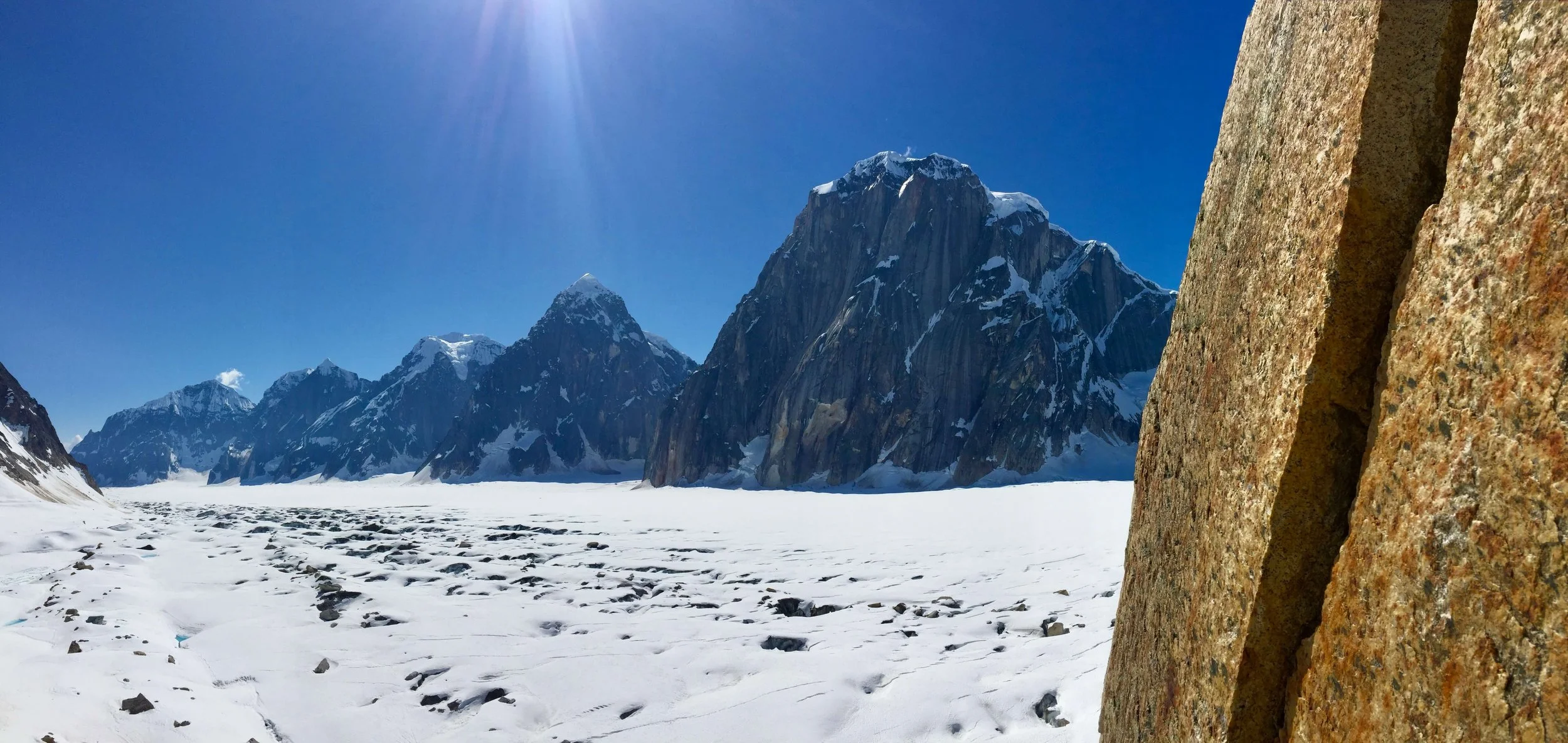 Golden granite splitter crack in the foreground with the Ruth Gorge glacier in the background. 