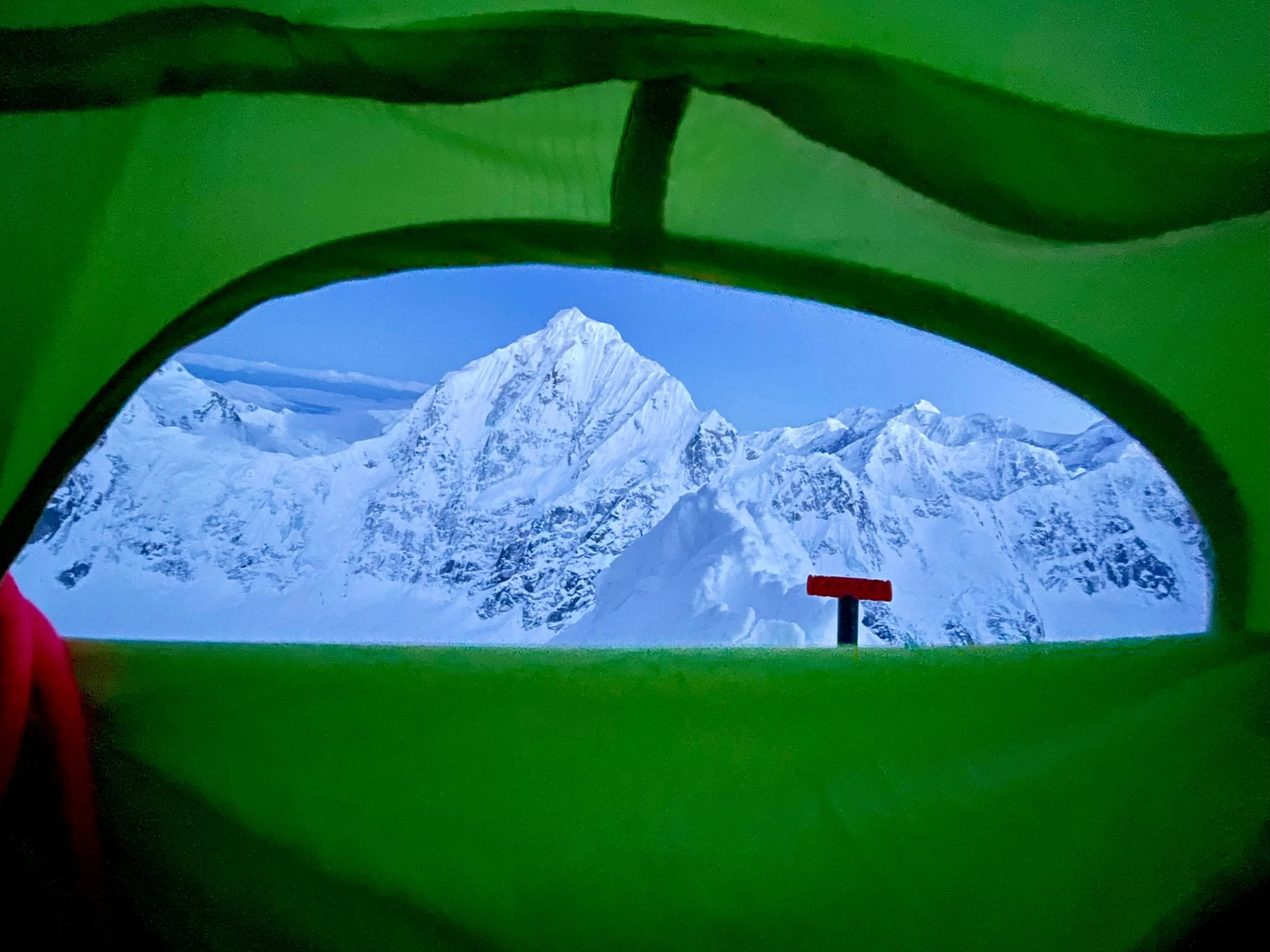 Alpenglow lighting up the north face of Mount Huntington from a high camp on Peak 11,300.