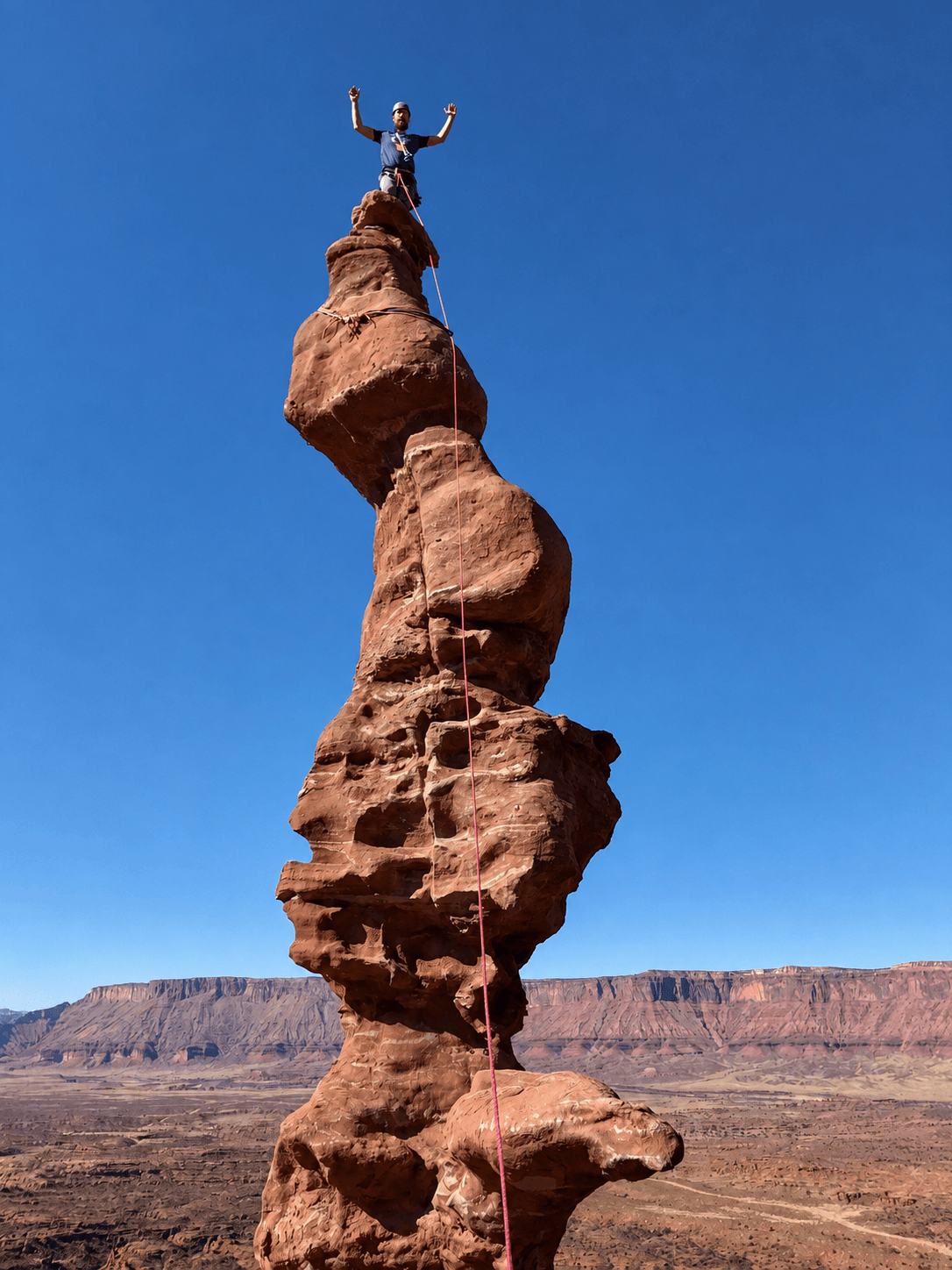 A climber on the corkscrew summit of Ancient Art.