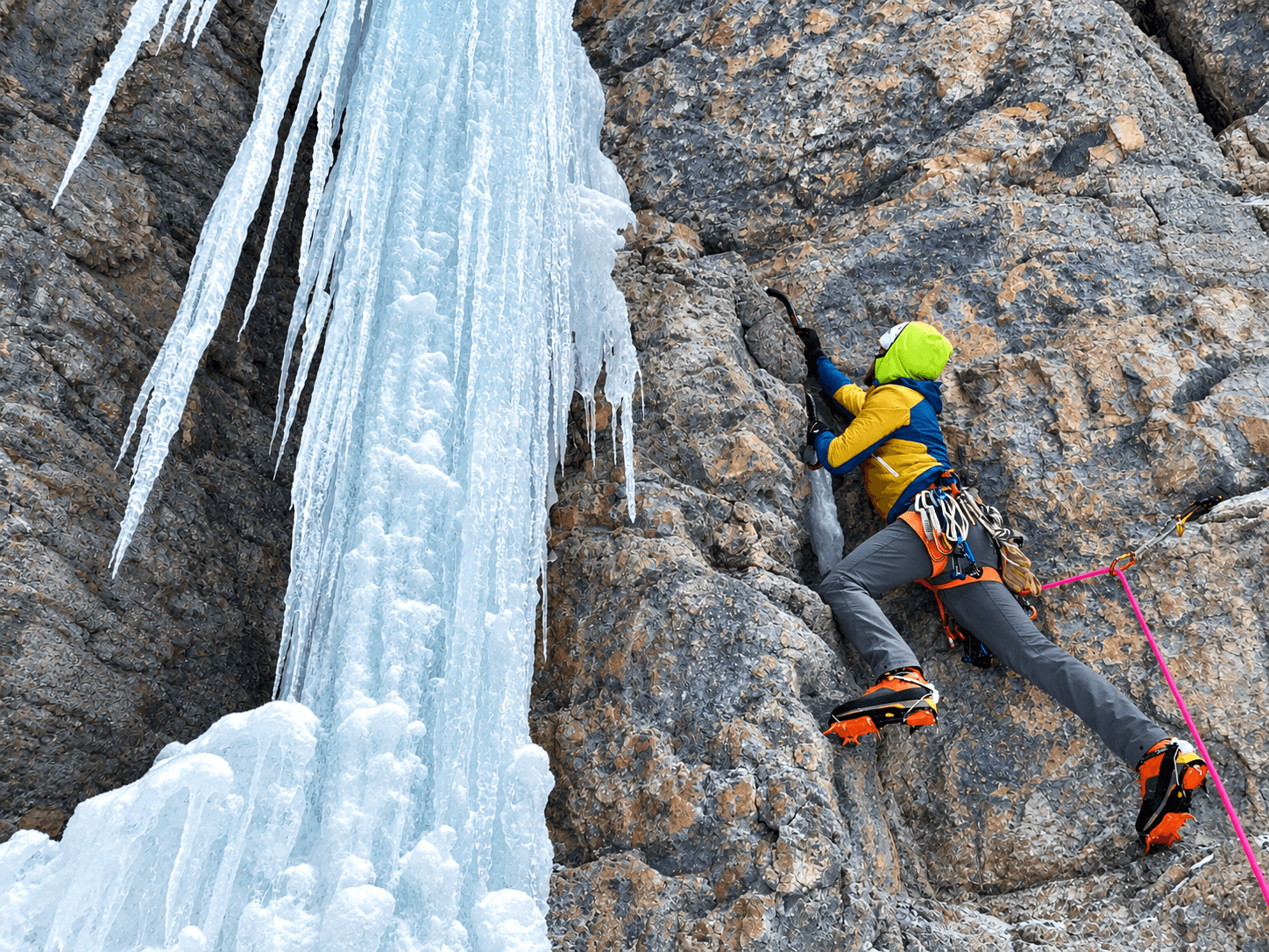 A guide leads a mixed climbing route on Camp Bird Road during an alpine climbing course.