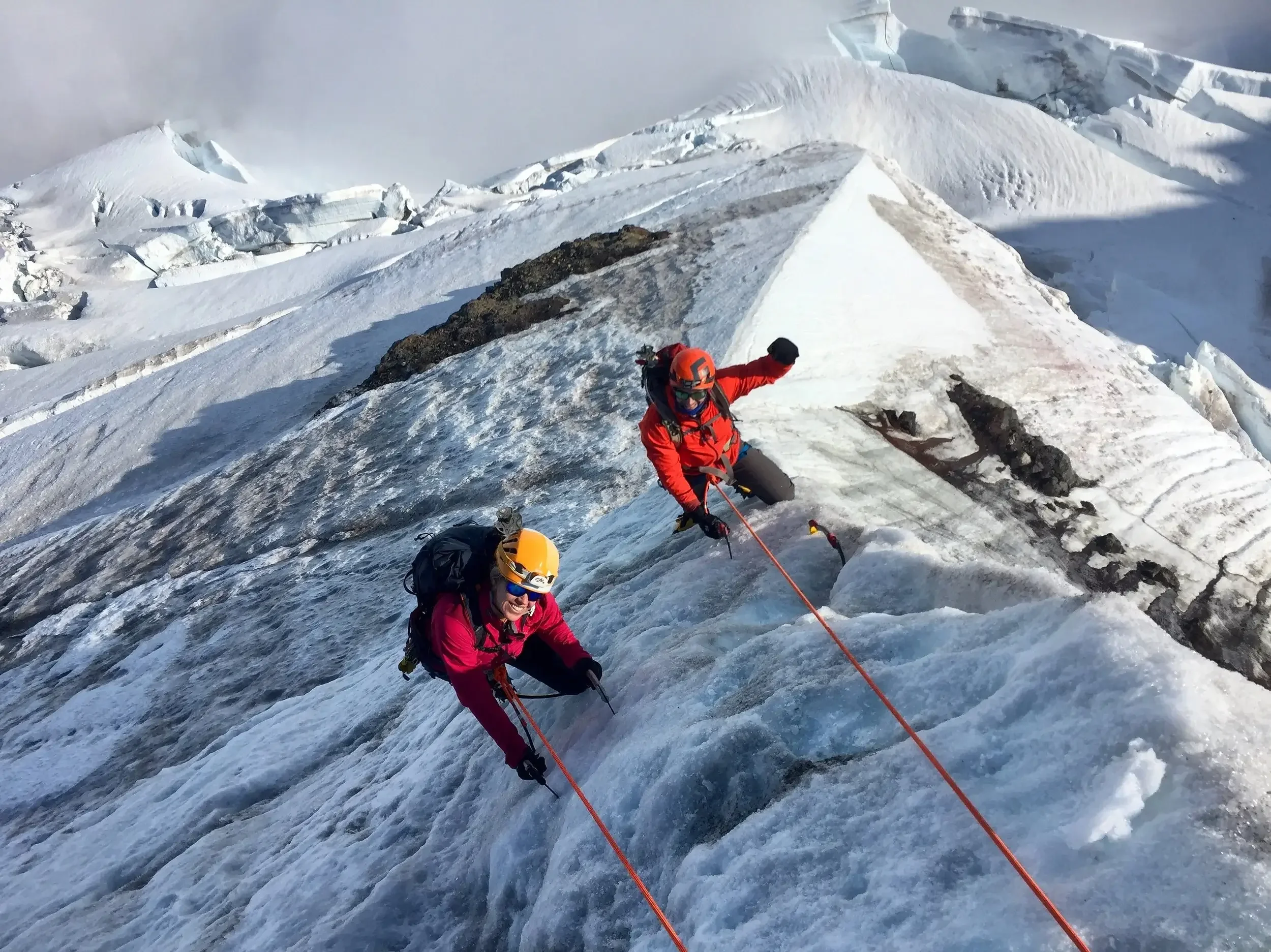 Two climbers smile midway up the ice step on the North Ridge.