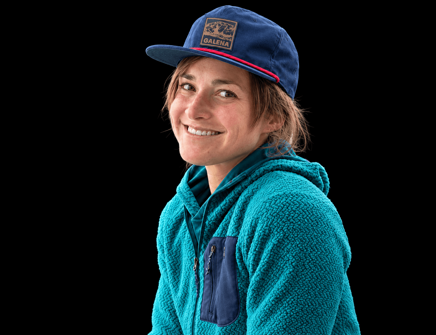 Skyward Mountaineering guide, Suzanna Lourie. She is wearing a blue fleece jacket and a blue baseball hat.