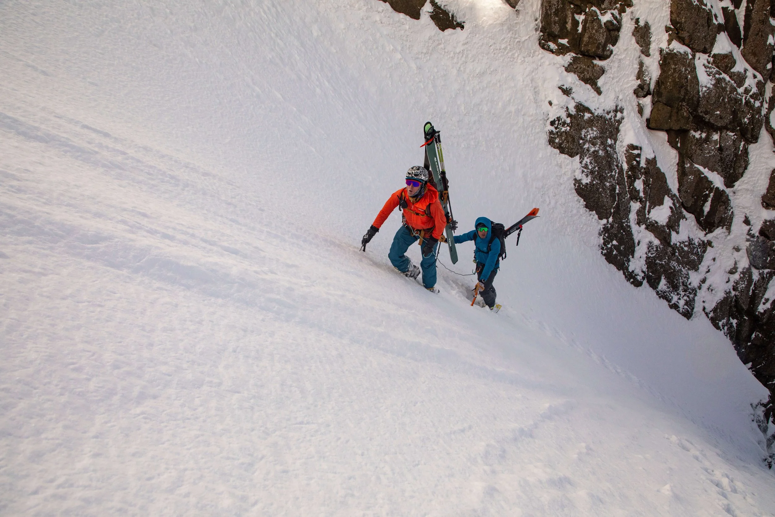 Two skiers climb up a steep couloir on Mount Sneffels during an Intro To Ski Alpinism Course.