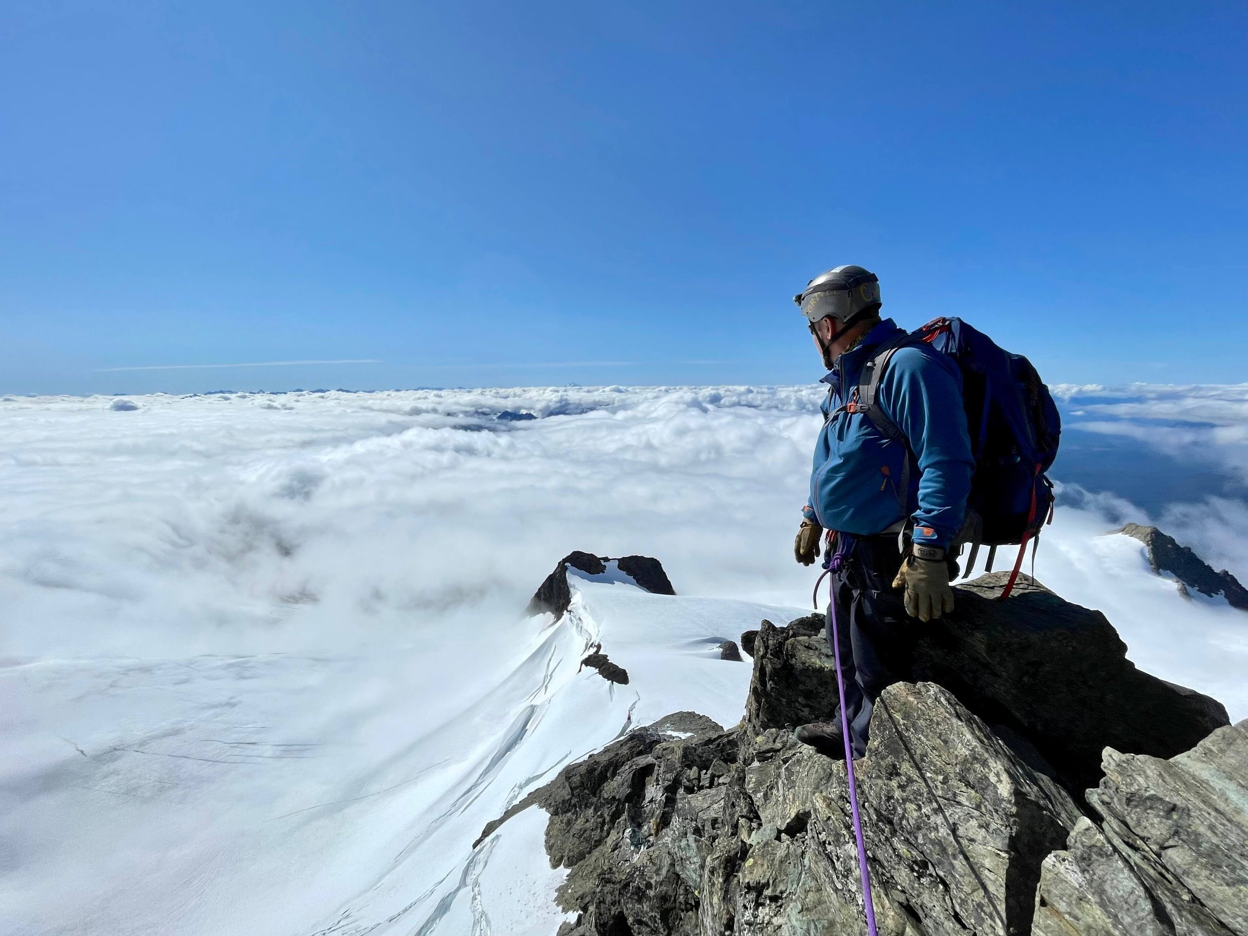On the summit of Mt. Shuksan with a sea of clouds below.