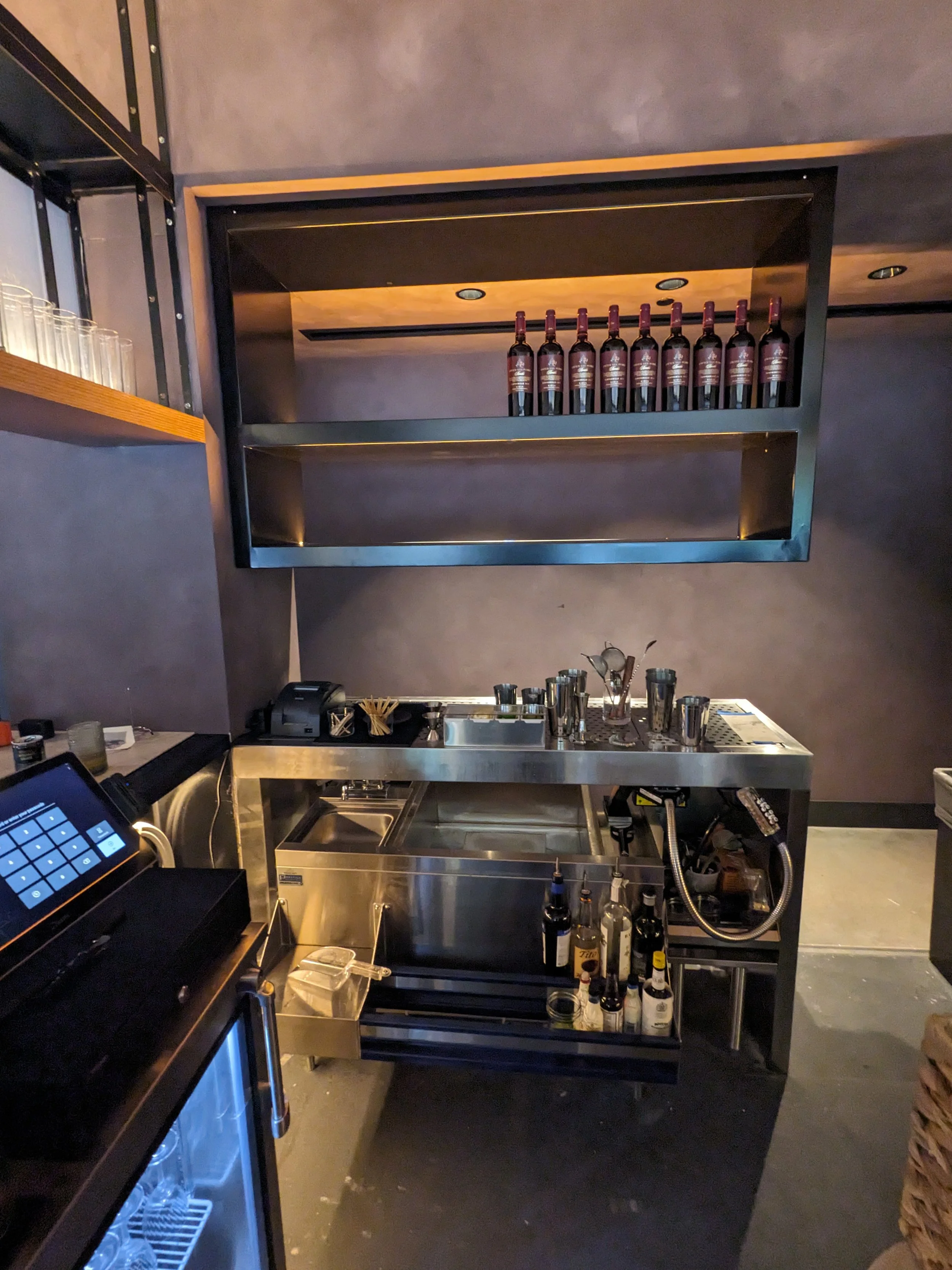 Custom bottle rack and drink mixing station.