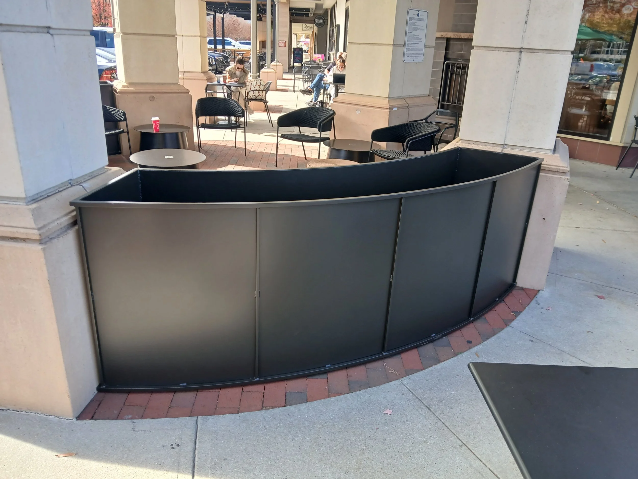 Decorative rolled metal planter boxes.