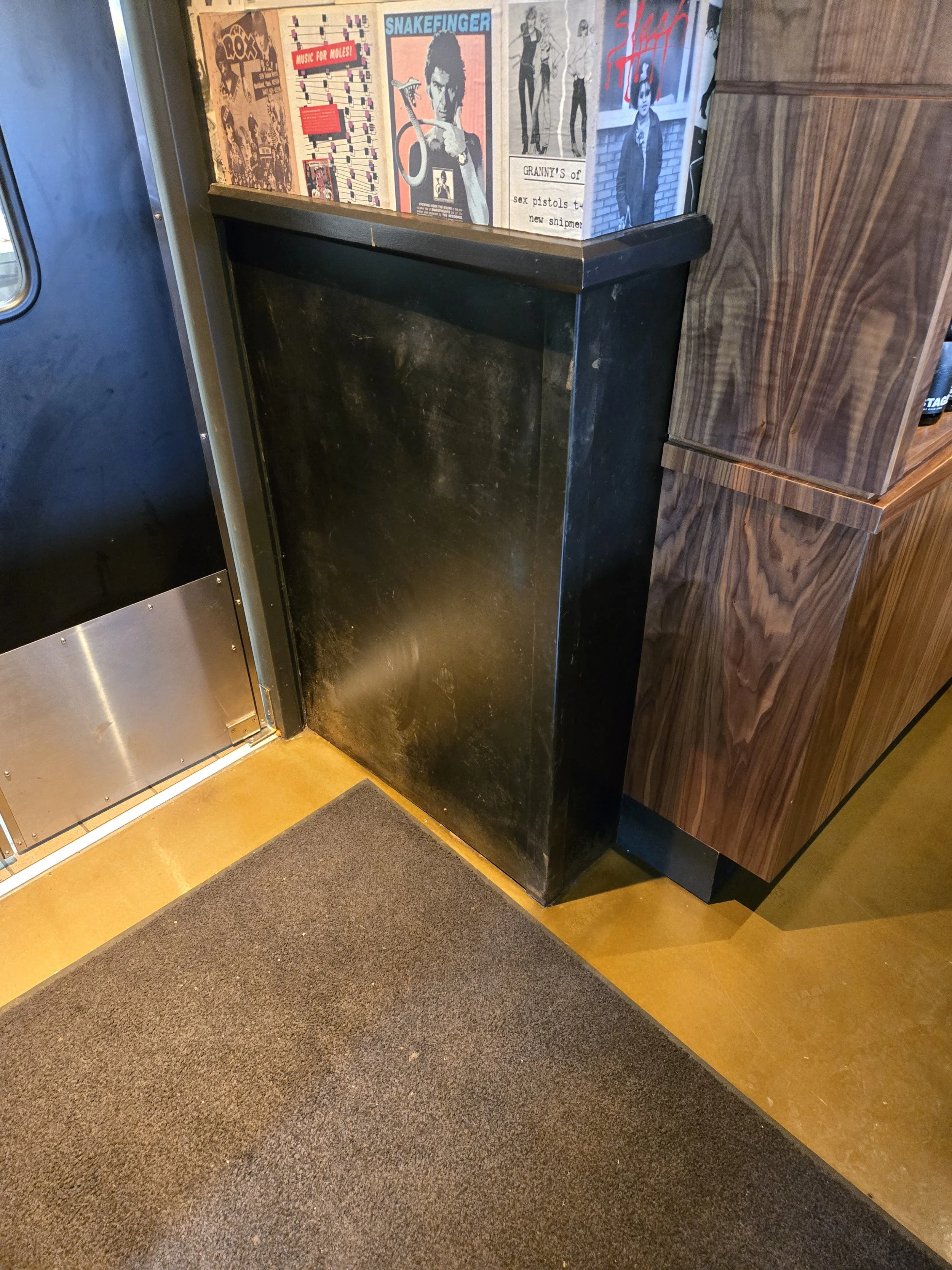 Chemically blackened steel wainscoting.