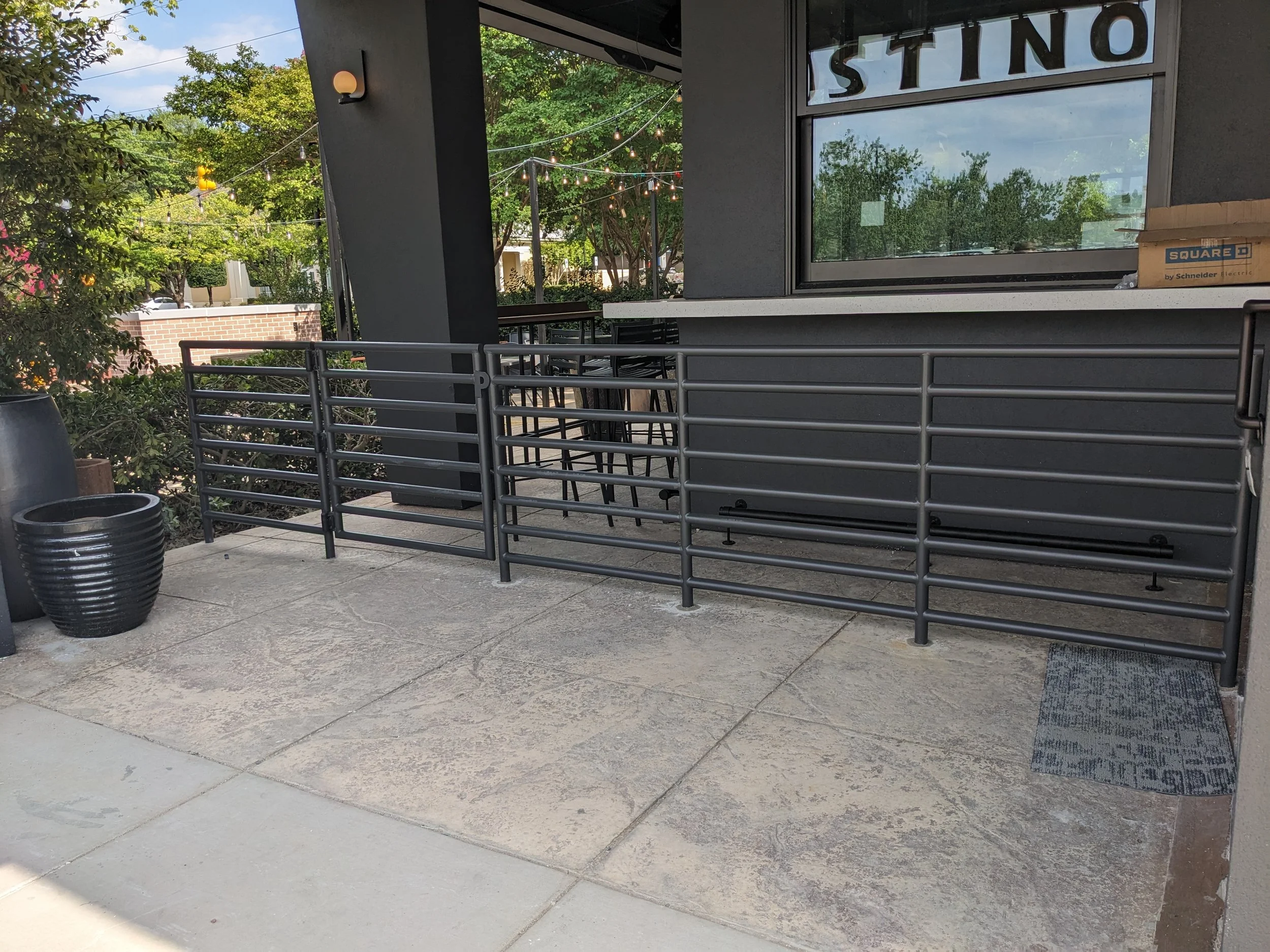 Decorative steel rails with gate at Postino in Raleigh.